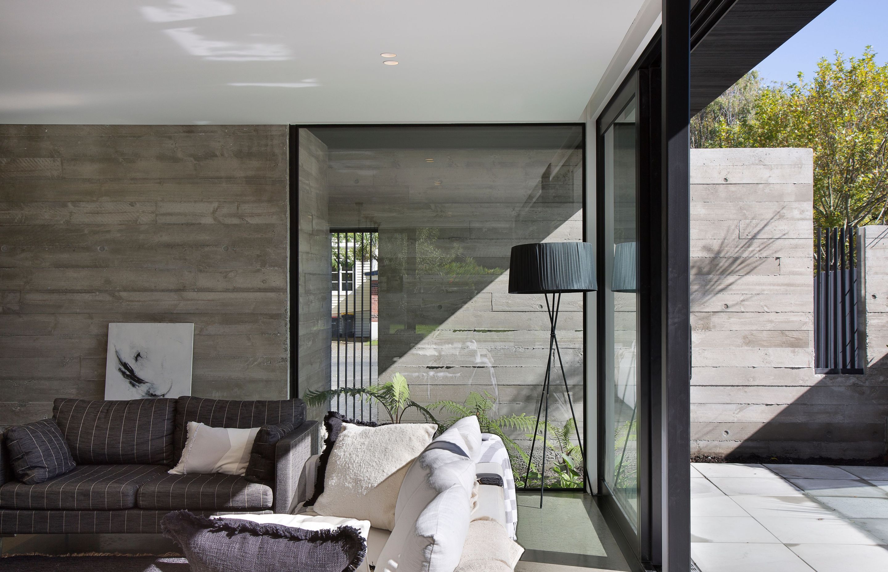 The poured concrete walls are exposed on both sides, providing an interesting texture that also forms part of the internal nature of the house.