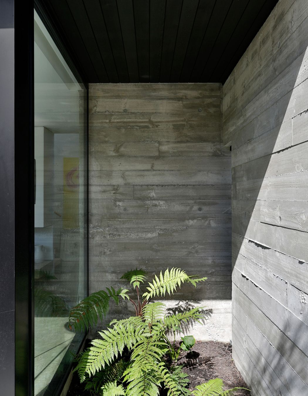 Rough-sawn timber shuttering creates textured walls that ooze out at the edges.