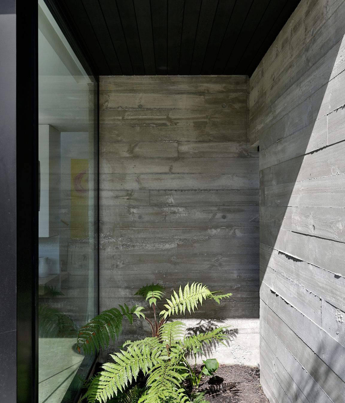Rough-sawn timber shuttering creates textured walls that ooze out at the edges.