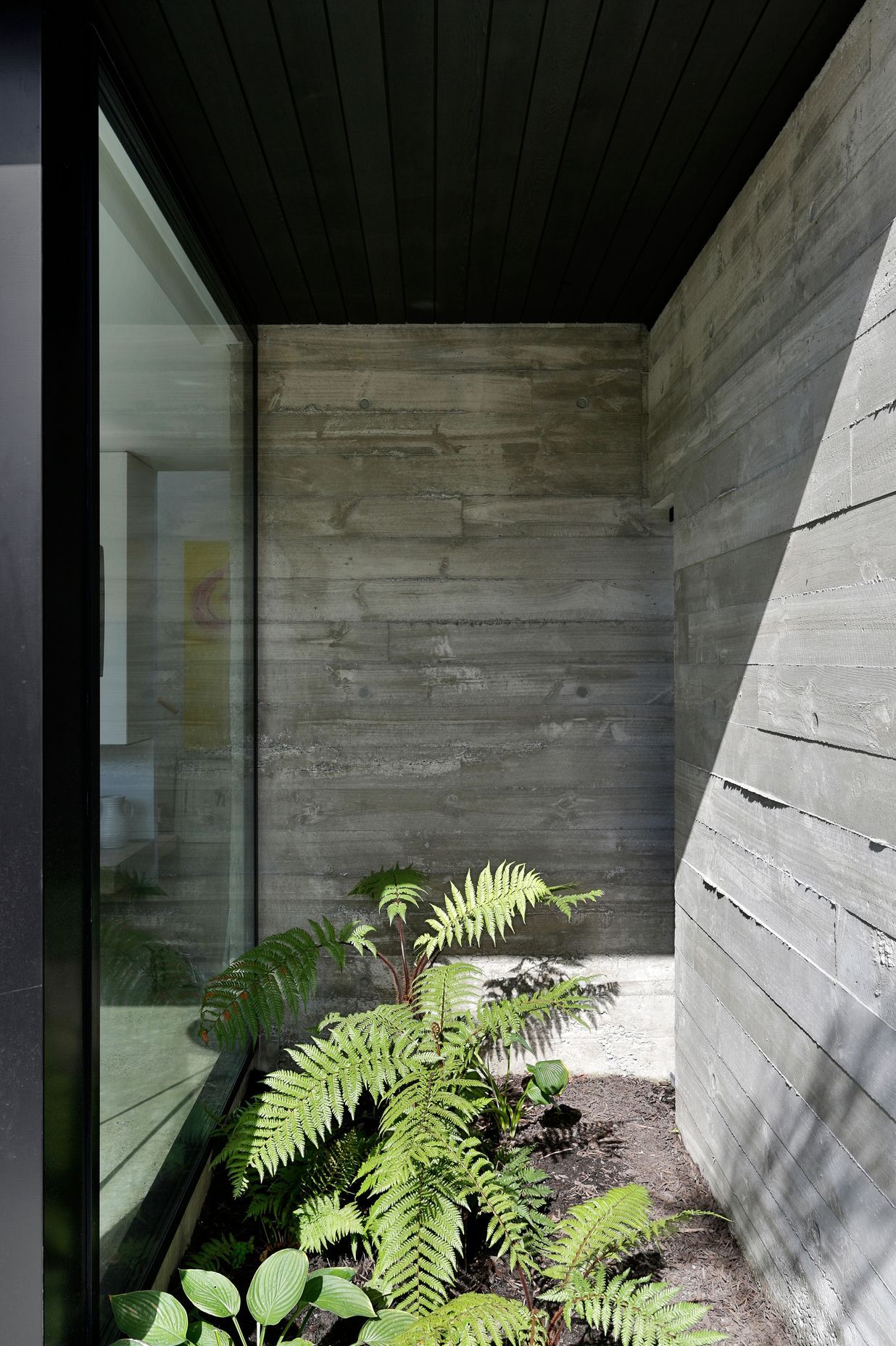 Rough-sawn timber shuttering creates textured walls that ooze out at the edges.
