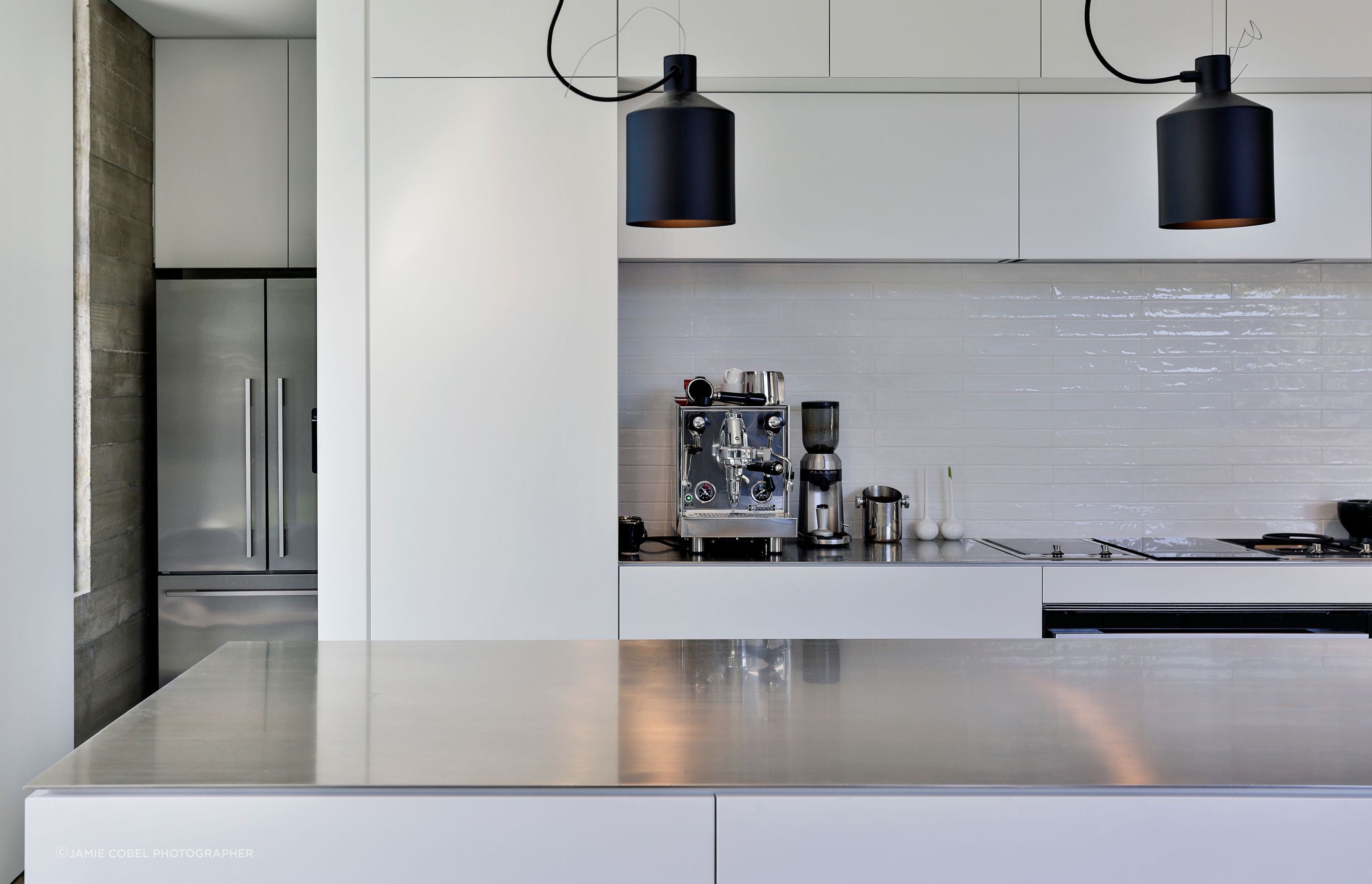 Behind the kitchen is a scullery and laundry with a window view of the garden.