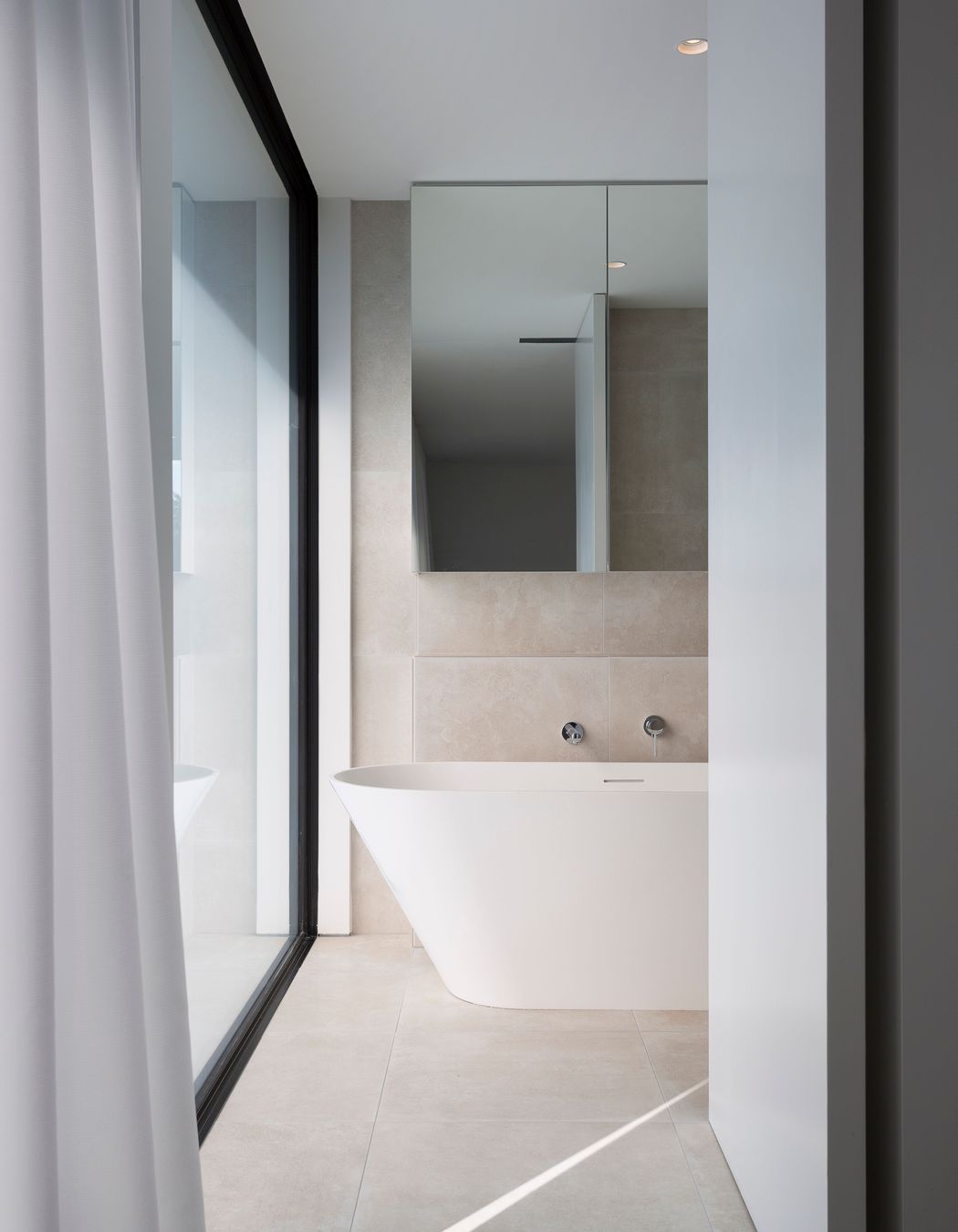 A huge window creates an outlook in the master bathroom.