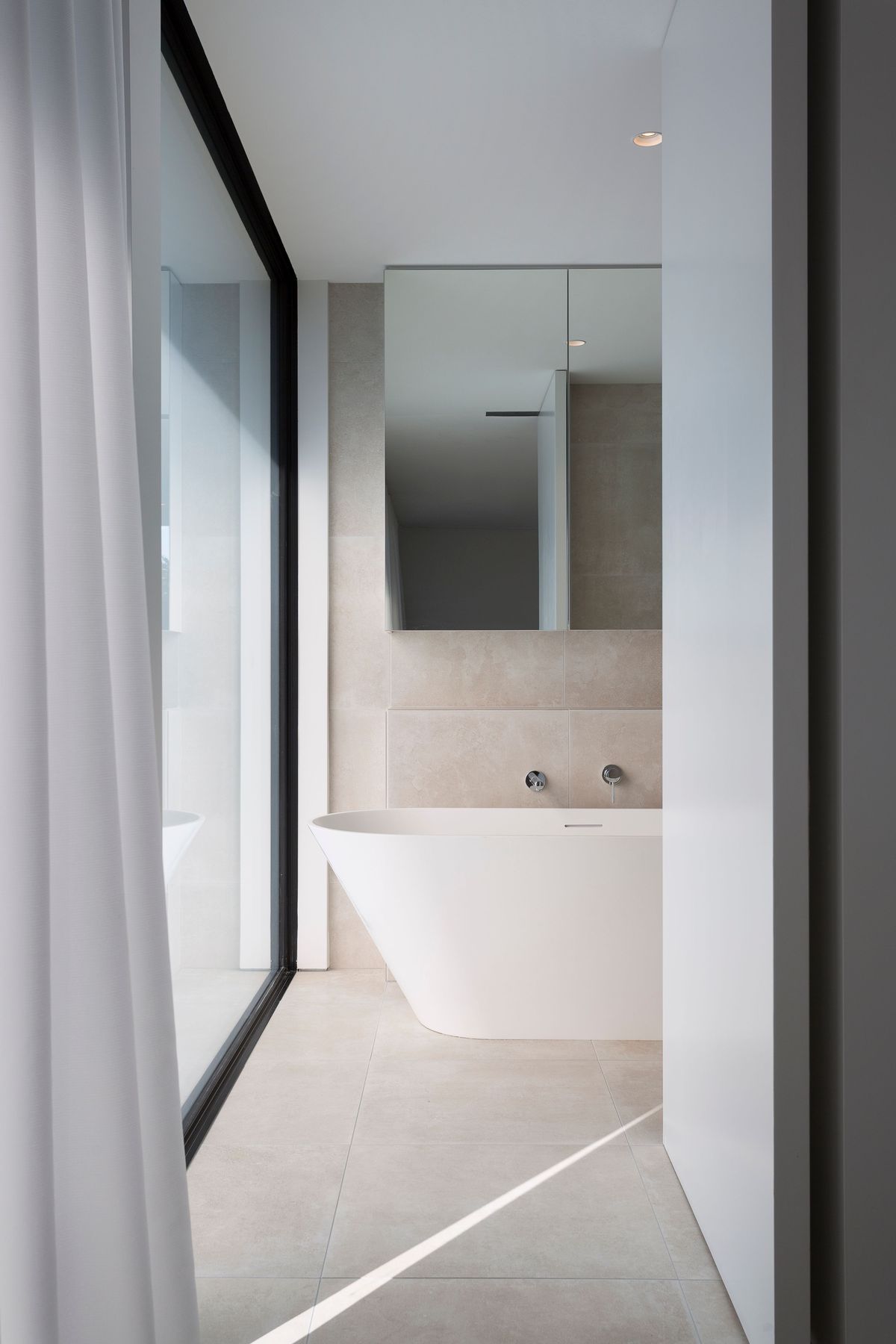 A huge window creates an outlook in the master bathroom.
