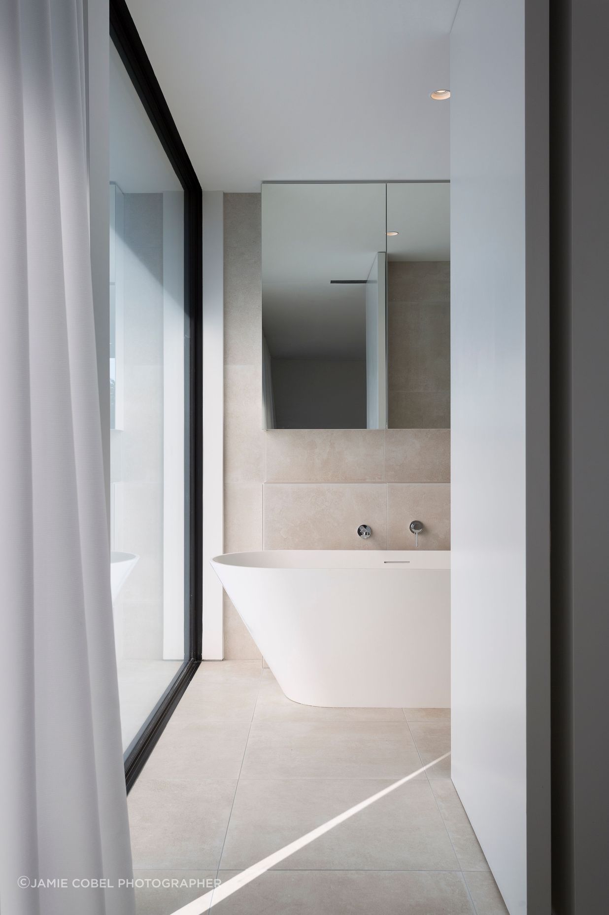 A huge window creates an outlook in the master bathroom.