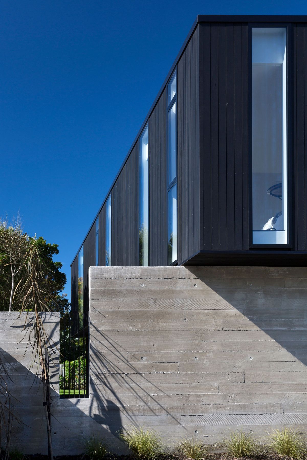 Rectangular cut-outs in the concrete walls emulate the penetrations in the upper box.