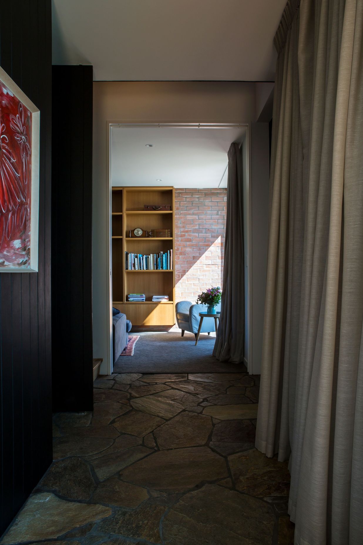 The ground-floor corridor leading to the media room with its crazy paving floor.