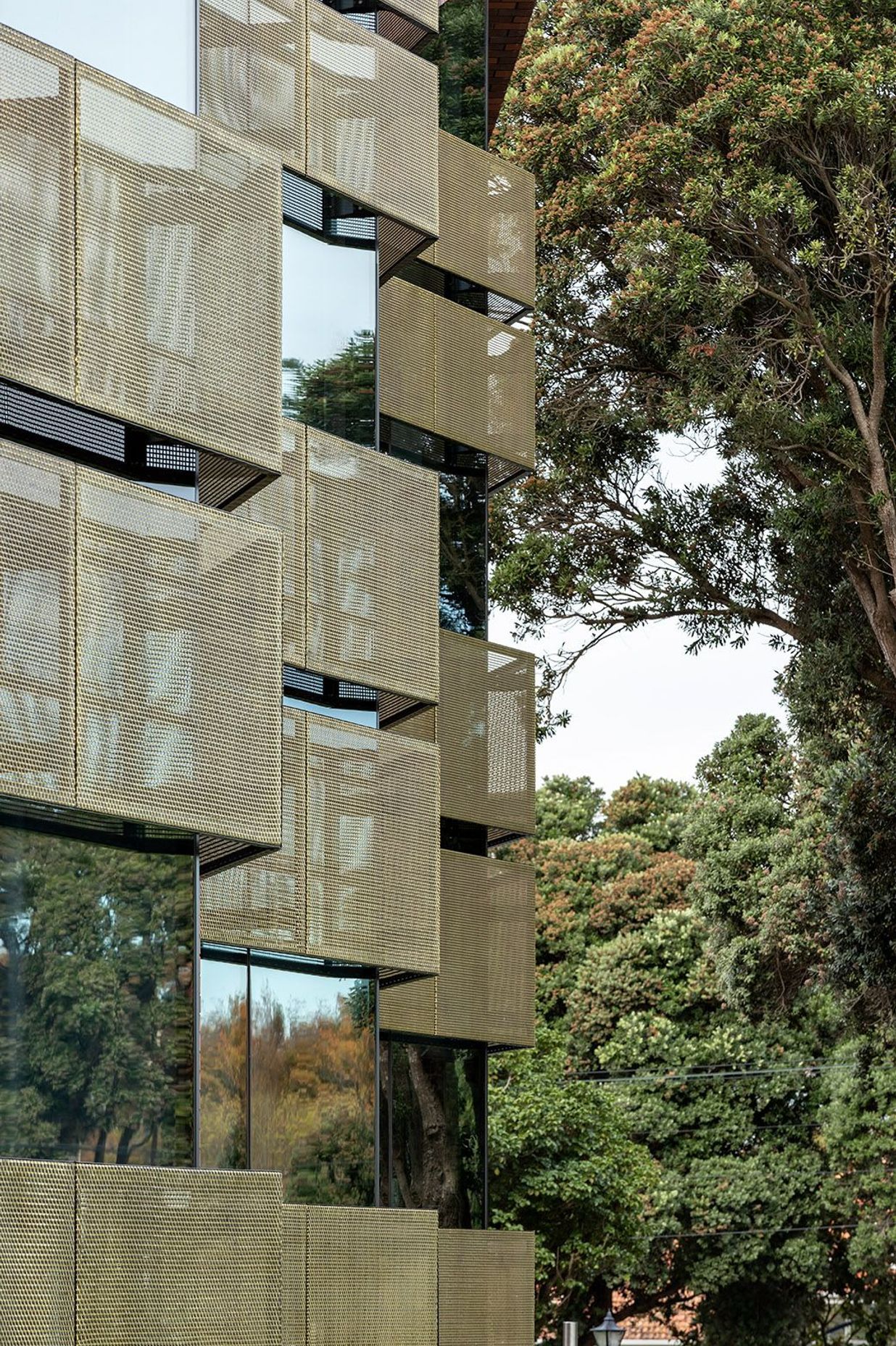 Brass sun-shade screens protect against glare and minimise solar gain wthin the interior. The use of brass is a nod to the traditional fixtures seen in the old school.