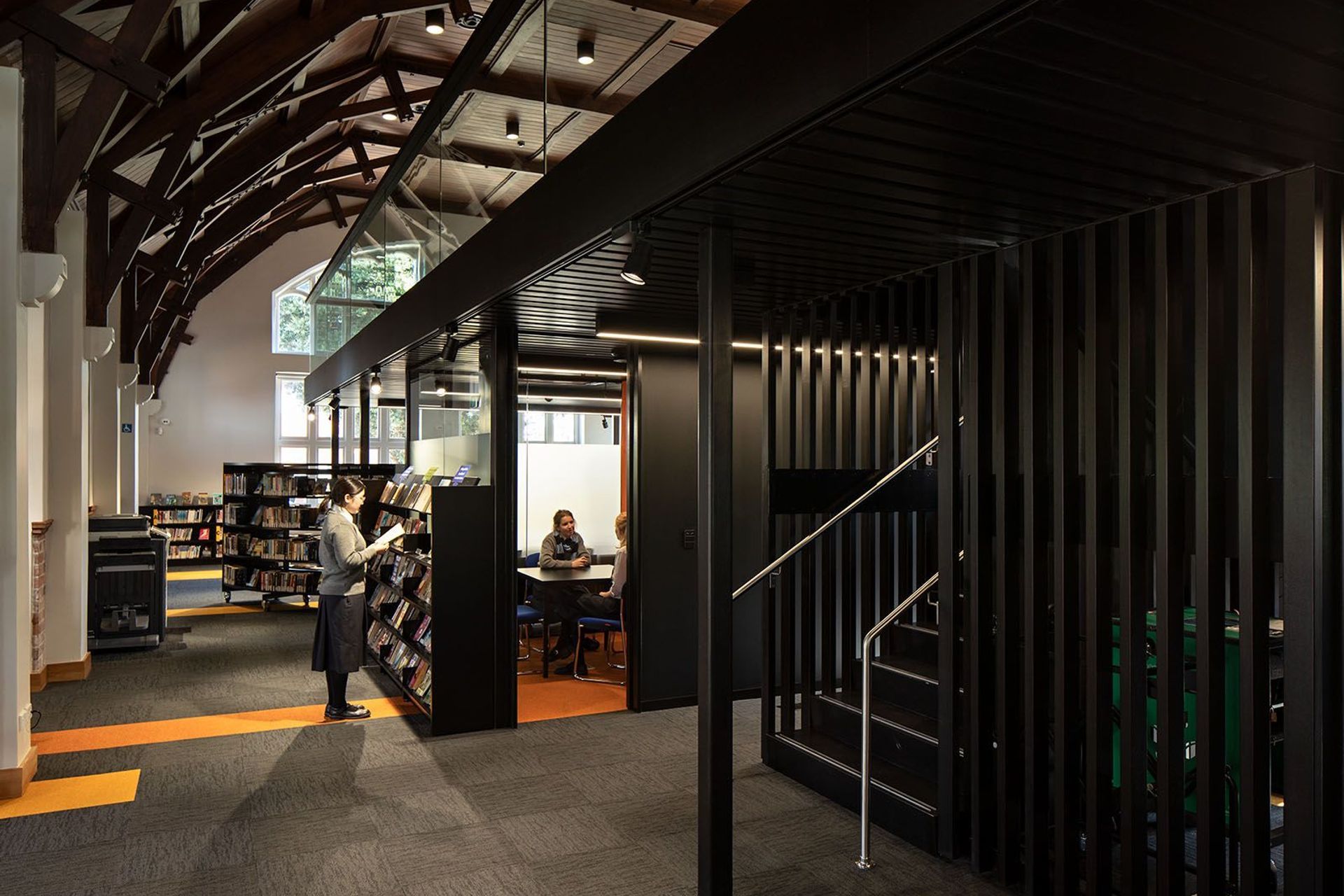 In the restored heritage library, a contemporary 'floating' mezzanine is free of the oriignal structure, creating a happy marriage between new and old.