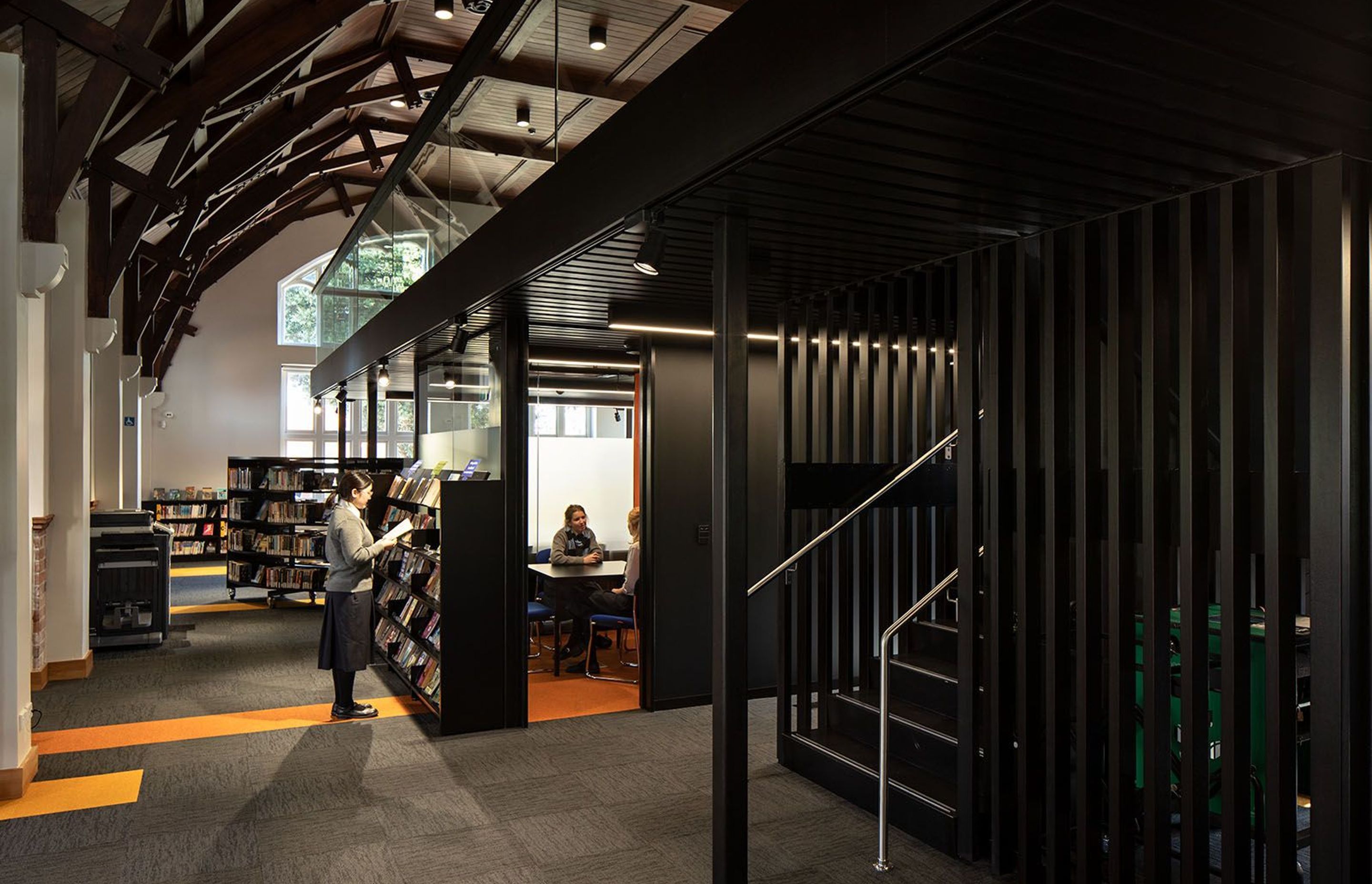 In the restored heritage library, a contemporary 'floating' mezzanine is free of the oriignal structure, creating a happy marriage between new and old.