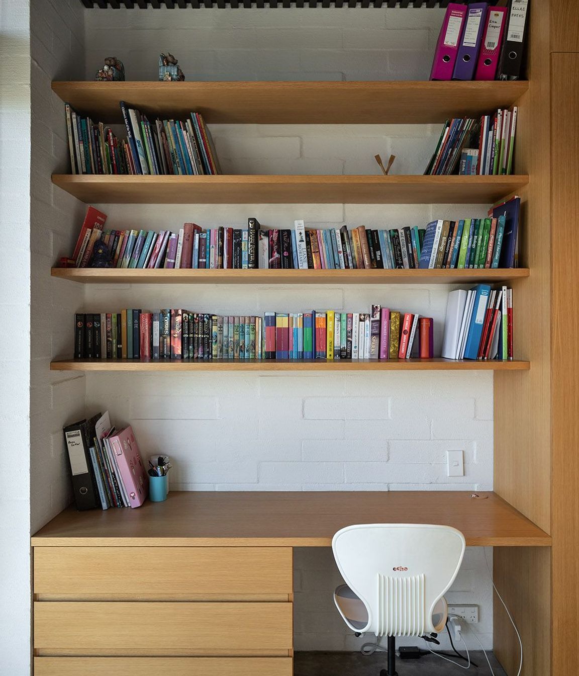 A dark cedar ceiling complements the lighter cabinetry and concrete block walls.