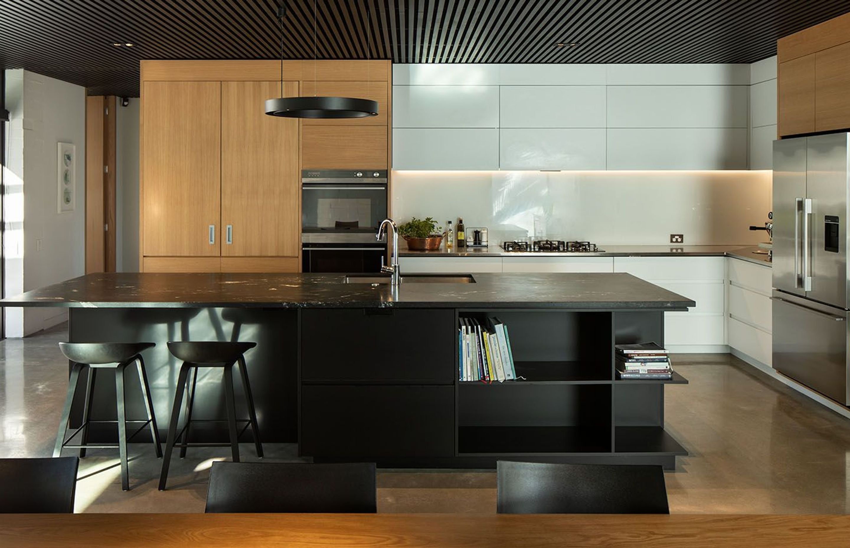 A central aspect of the interior scheme - the acoustic ceddar batten ceiling - continues seamlessly from the open plan living, kitchen and dining area into the covered outdoor courtyard.