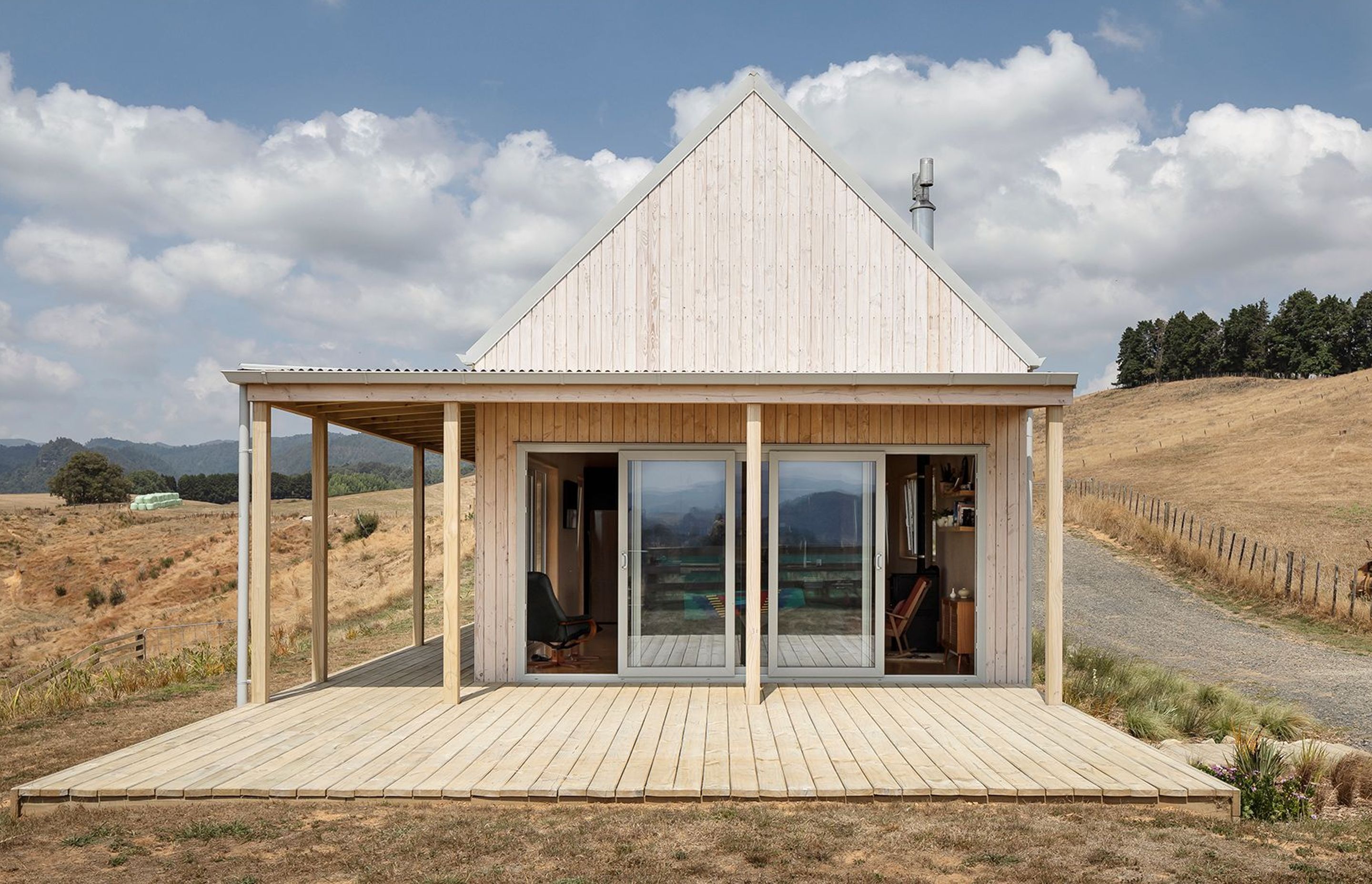 The south-western gable end hosts the lounge area, leading out onto a verandah that traverses the length of the building facing west.