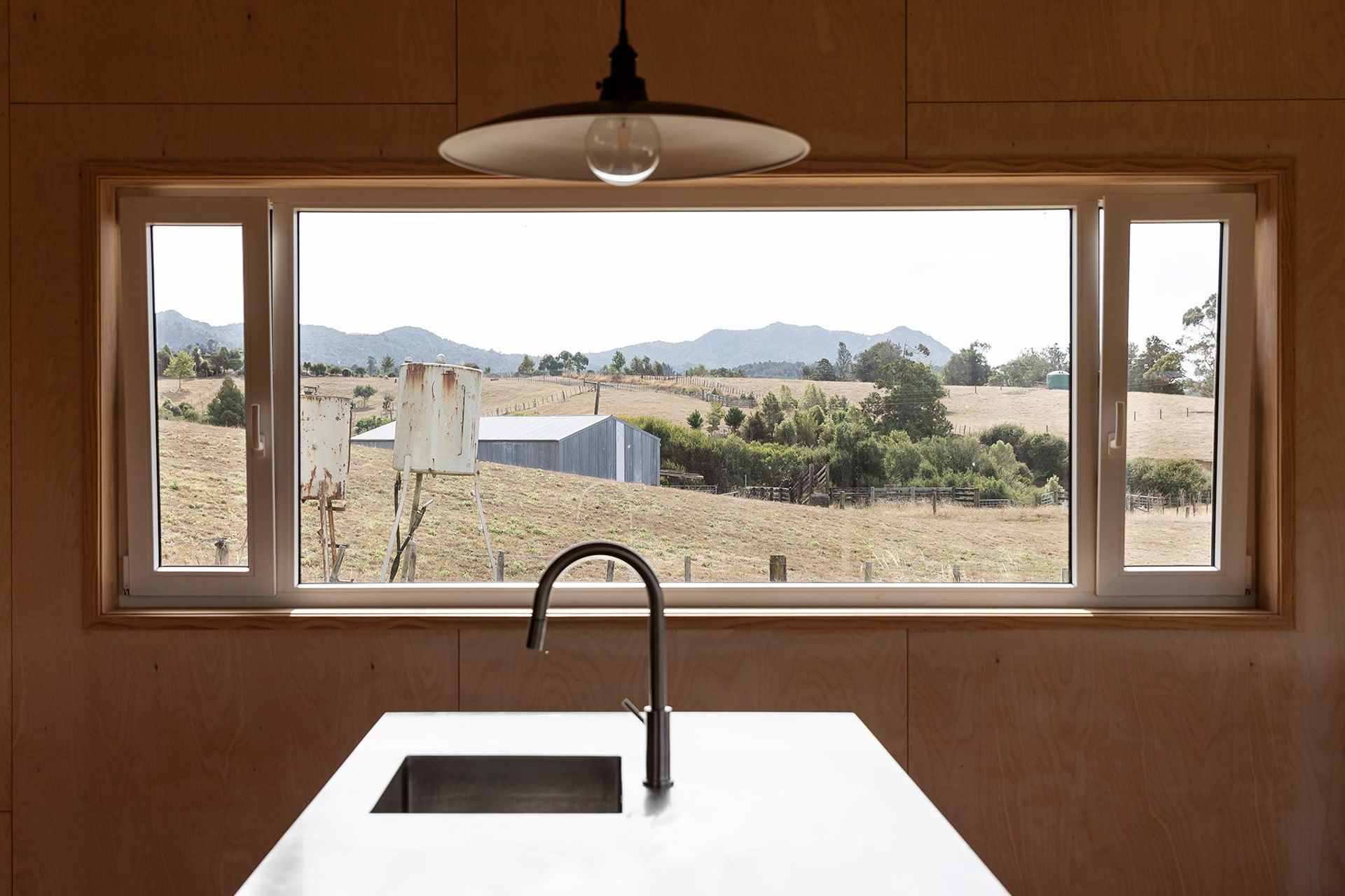 The rural view from the kitchen island. The double-glazed windows utilise Euro-style tilt-and-pivot joinery that is thermally broken to prevent cold bridging.