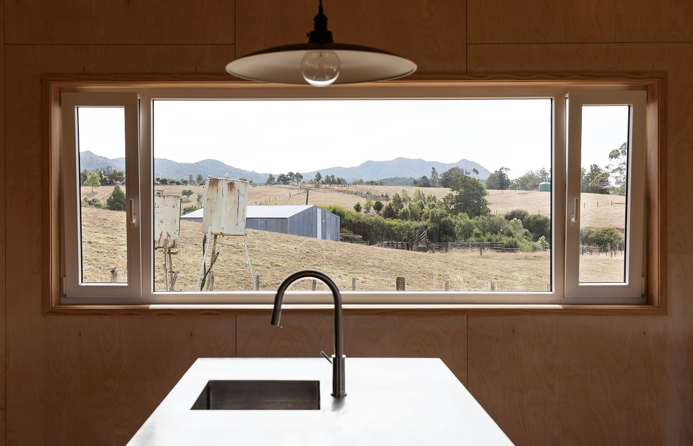 The rural view from the kitchen island. The double-glazed windows utilise Euro-style tilt-and-pivot joinery that is thermally broken to prevent cold bridging.