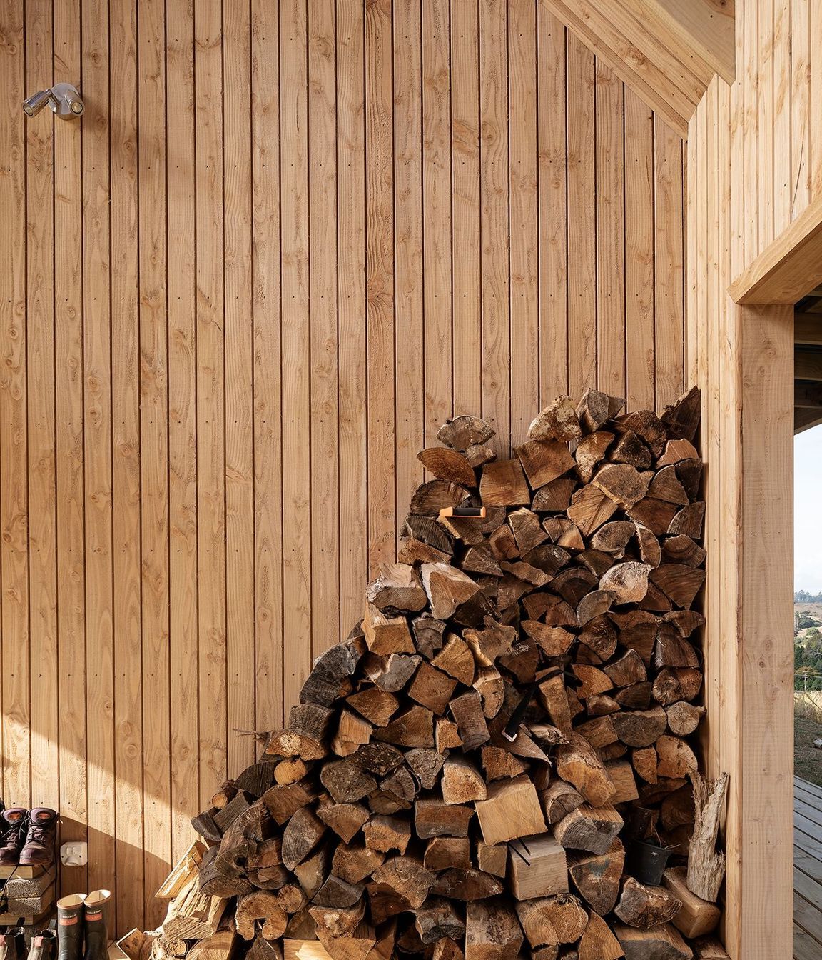 The firewood stack is kept dry and handy to reach.