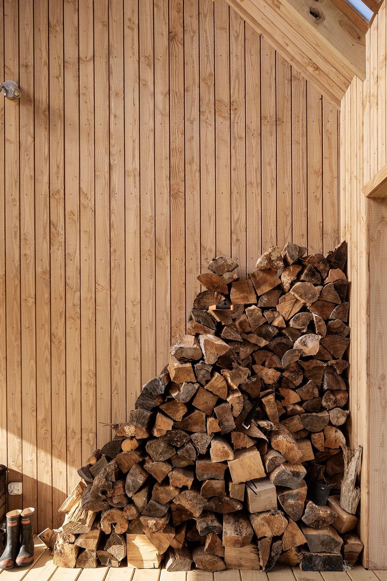 The firewood stack is kept dry and handy to reach.