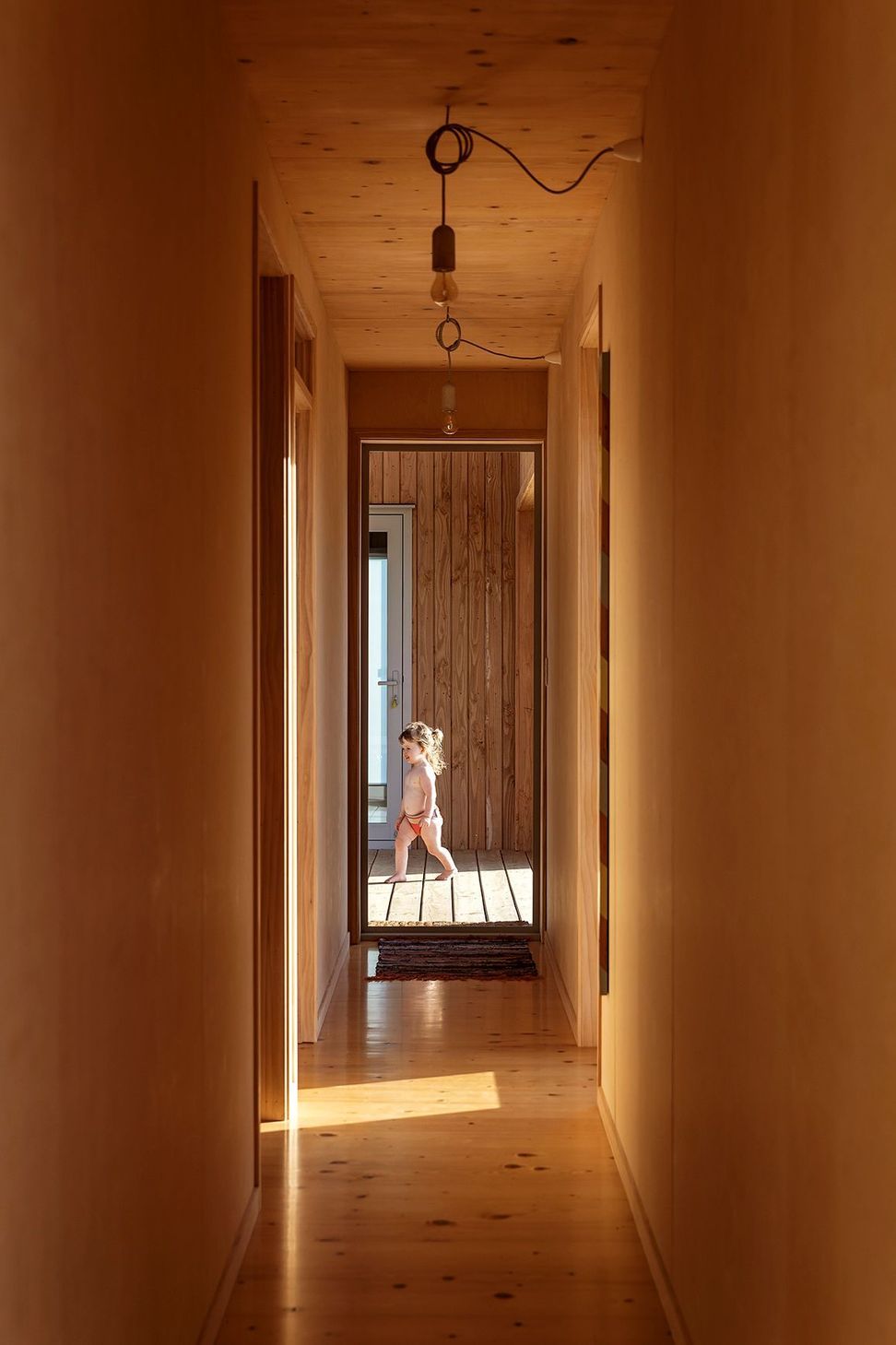 Two bedrooms and a bathroom lead of the corridor.
