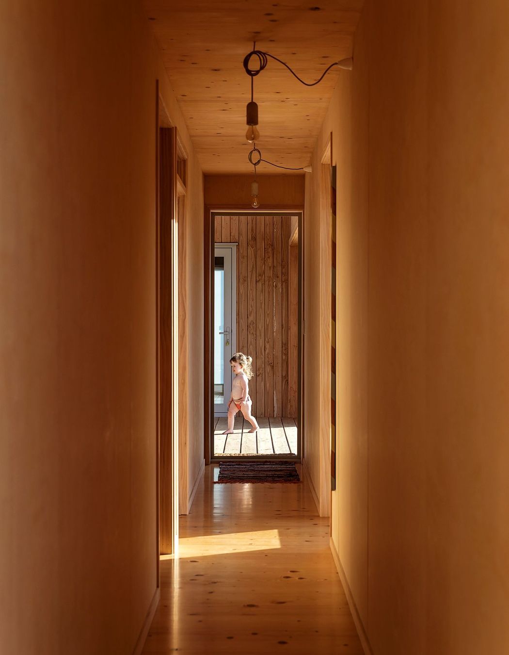 Two bedrooms and a bathroom lead of the corridor.