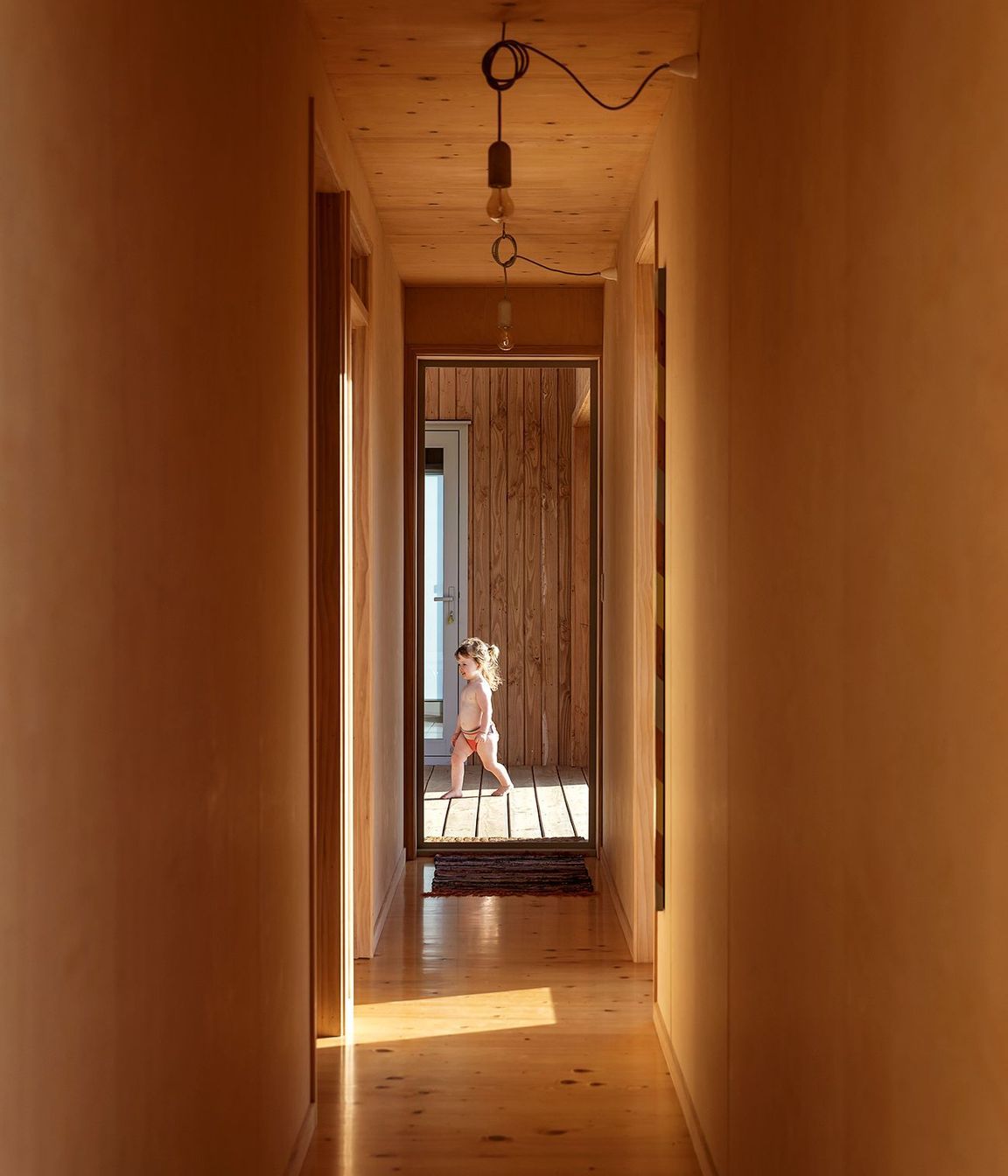 Two bedrooms and a bathroom lead of the corridor.