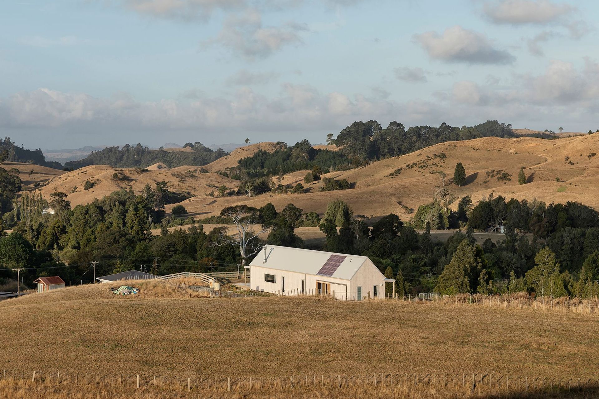 The east and north-facing elevations of Karangahake House, sitting within its farm setting. The owners plan to restore at least 11 acres of the property into native bush.