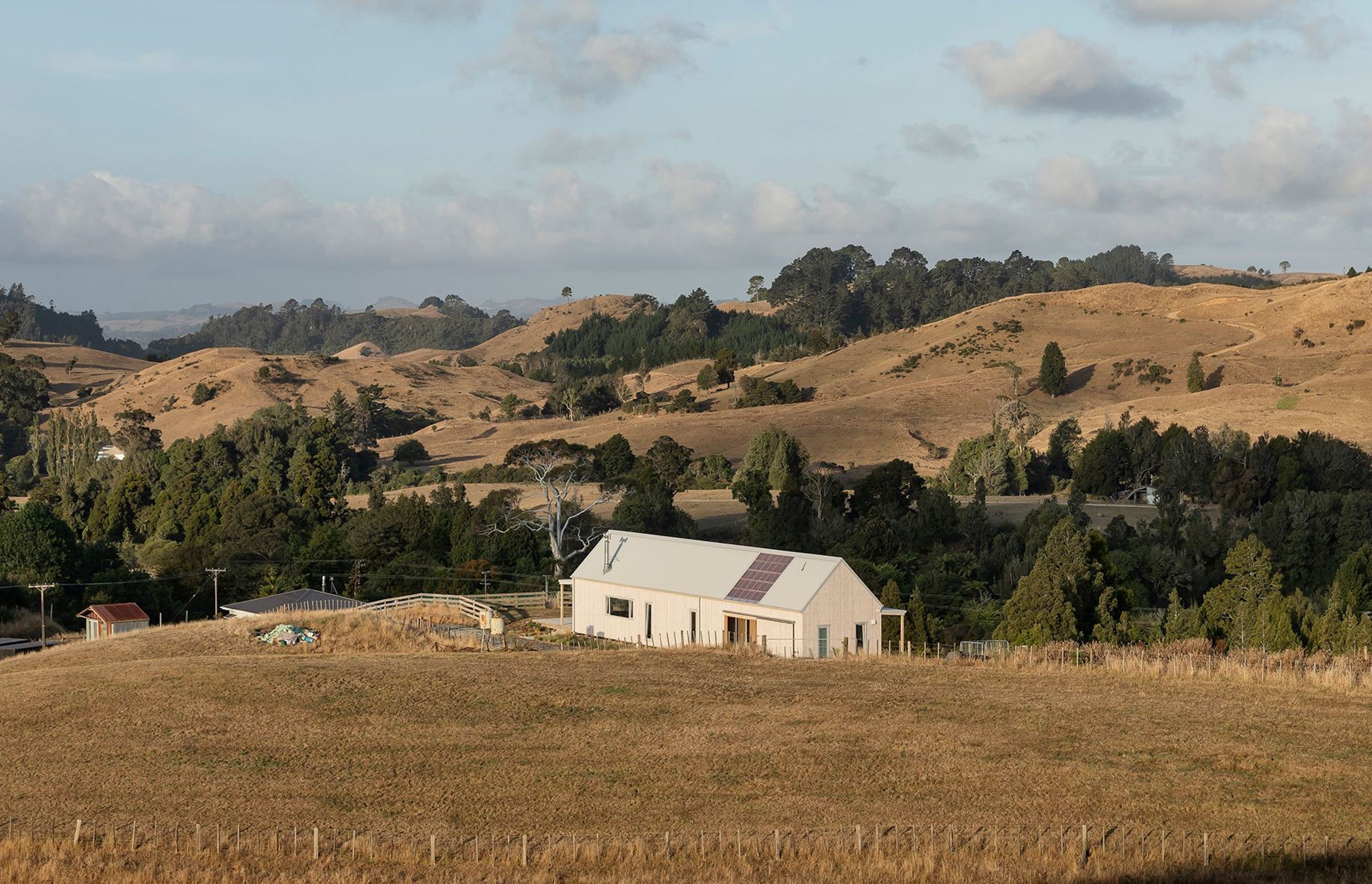 The east and north-facing elevations of Karangahake House, sitting within its farm setting. The owners plan to restore at least 11 acres of the property into native bush.