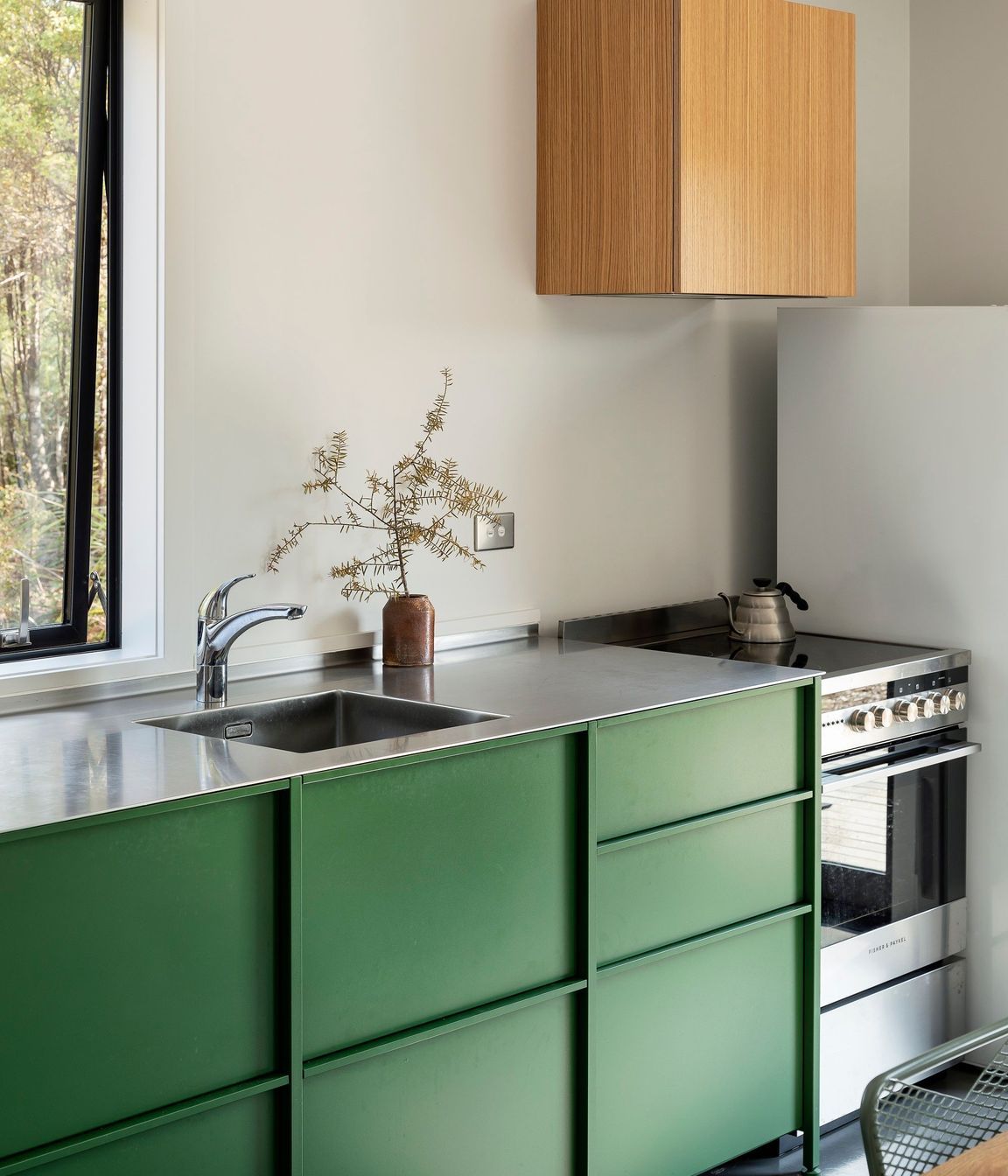 The kitchen is simple and functional, defined by the TKO cabinetry.