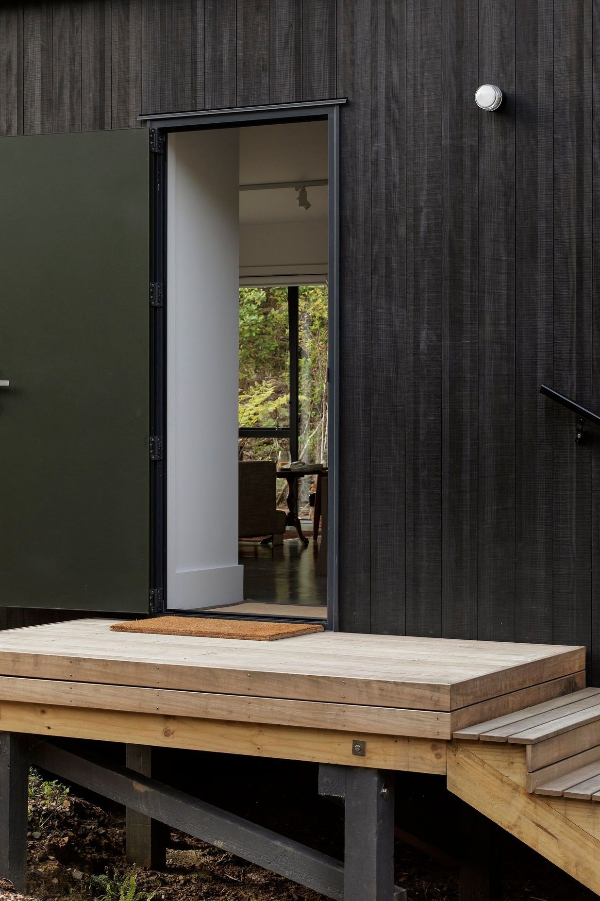 Stairs lead up to the main entrance, from which a choice is offered between the public and private parts of the home.