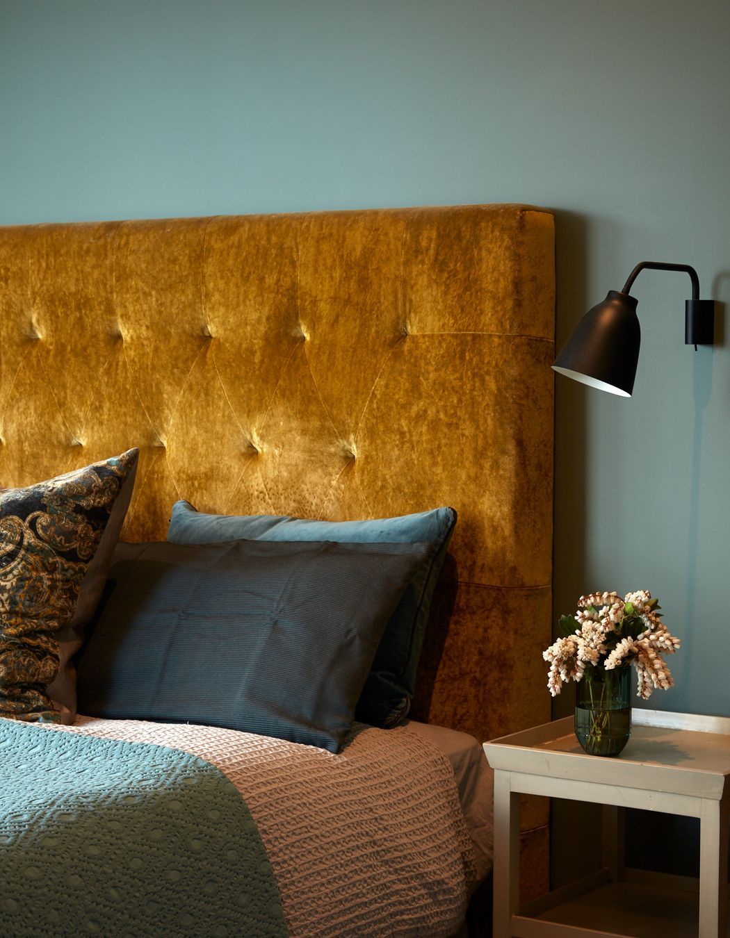 A sumptuous gold velvet bedhead adds to the autumnal colour palette.
