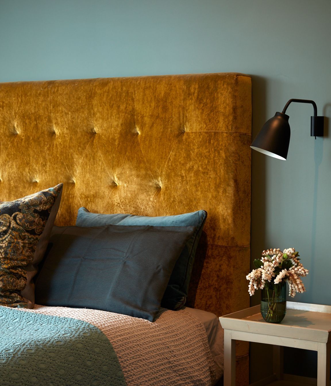 A sumptuous gold velvet bedhead adds to the autumnal colour palette.