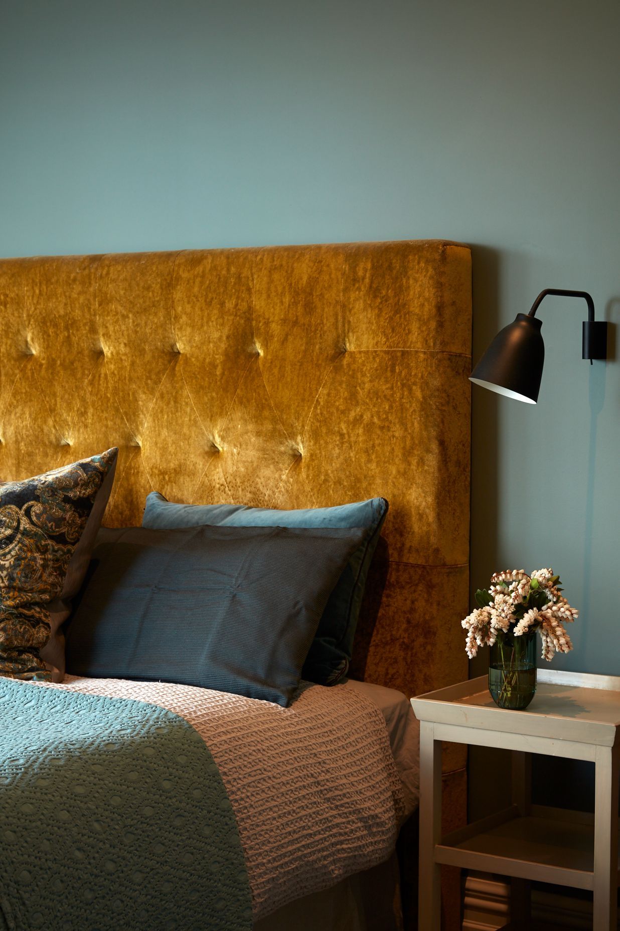 A sumptuous gold velvet bedhead adds to the autumnal colour palette.