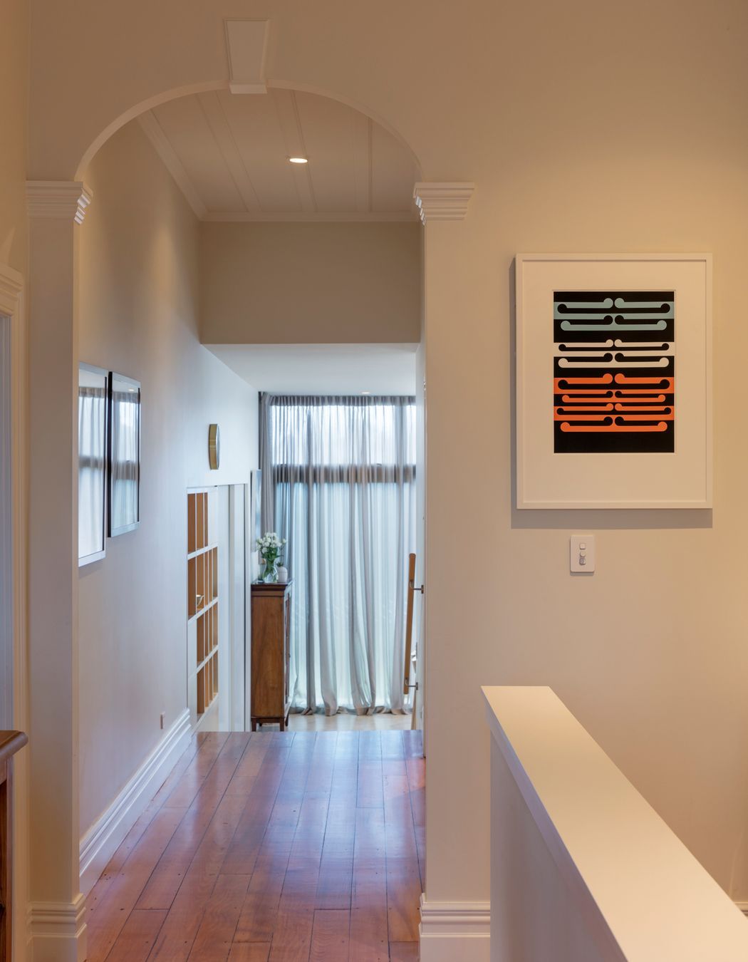 The villa hallway features arches, board-and-batten ceilings and kauri floors.