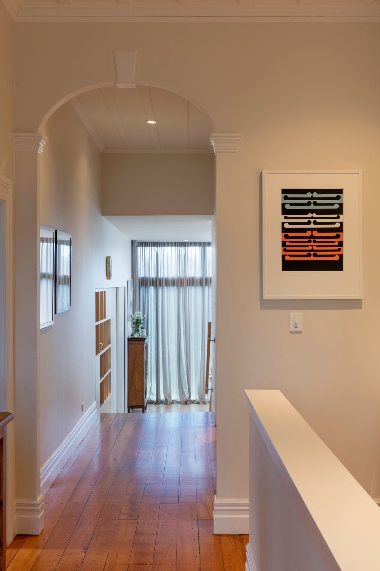 The villa hallway features arches, board-and-batten ceilings and kauri floors.