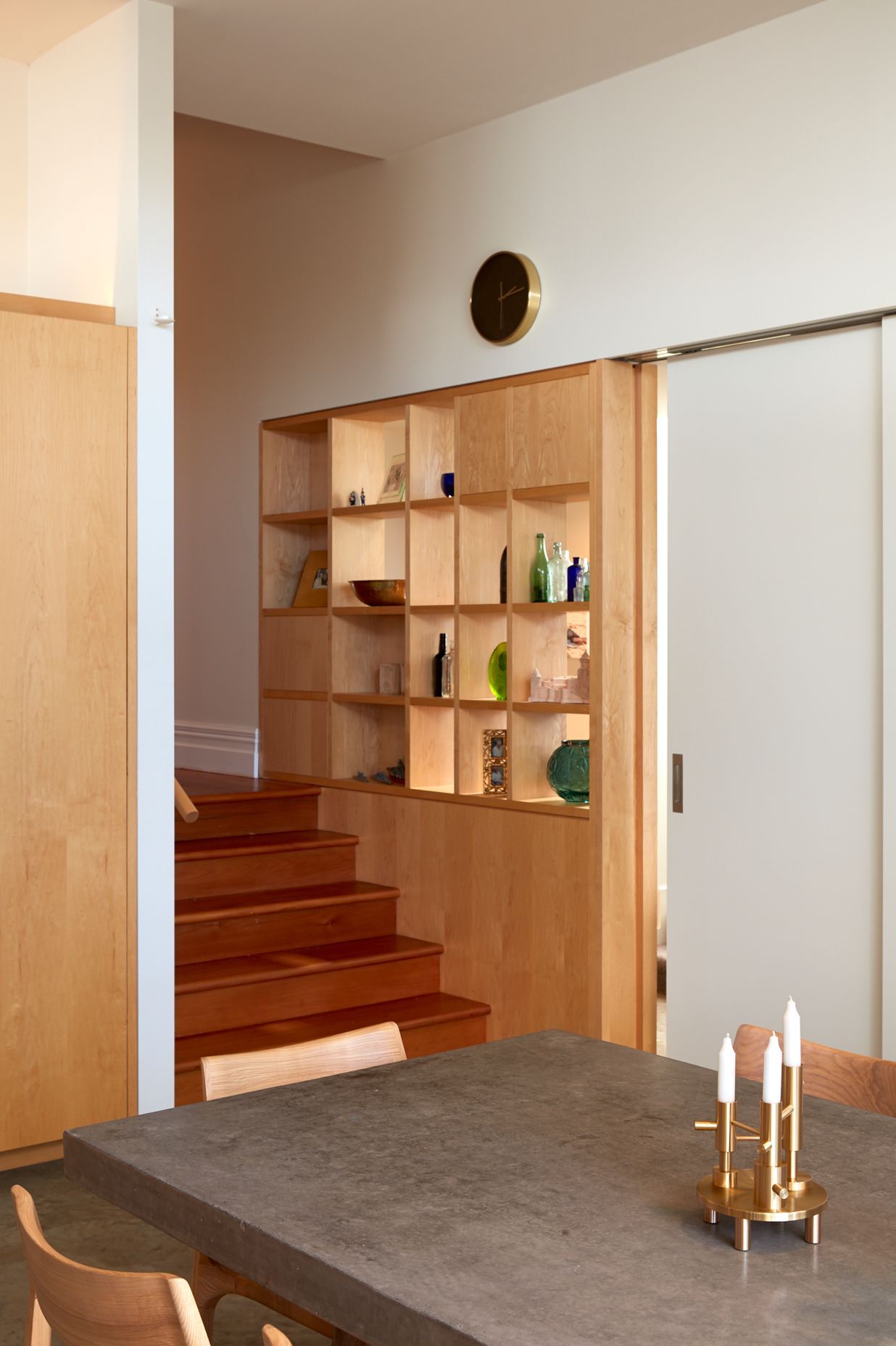 A built-in display case lines the steps up to the villa corridor.