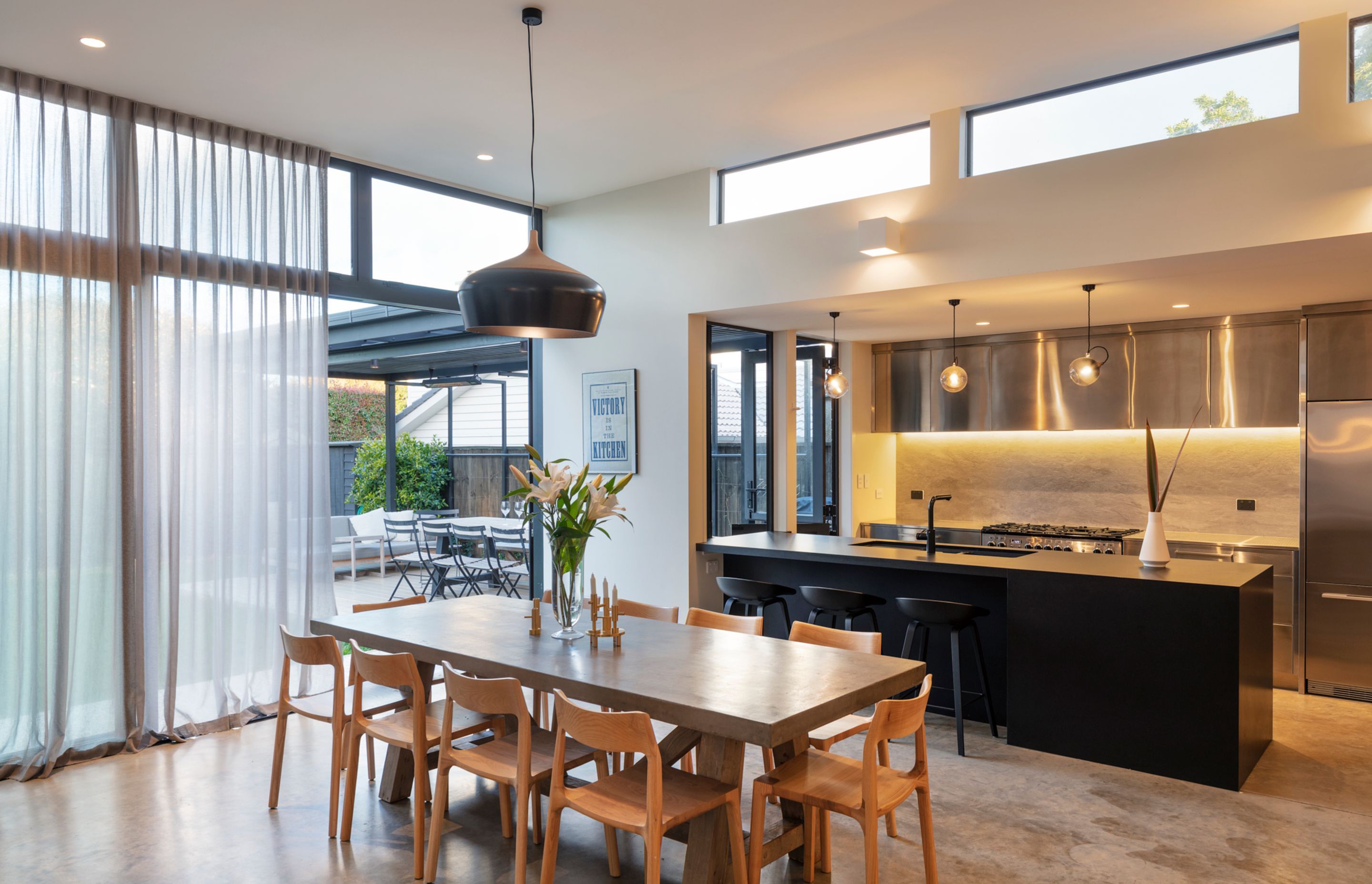 The kitchen and dining space leads out to the outdoor dining room.