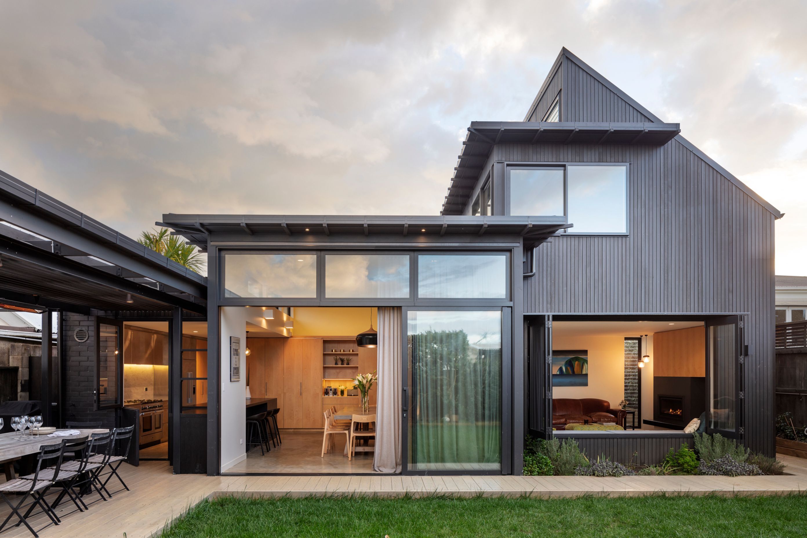 The new vertical shiplapped cedar-clad addition at the rear of the villa is stained dark to provide a clear distinction between old and new.