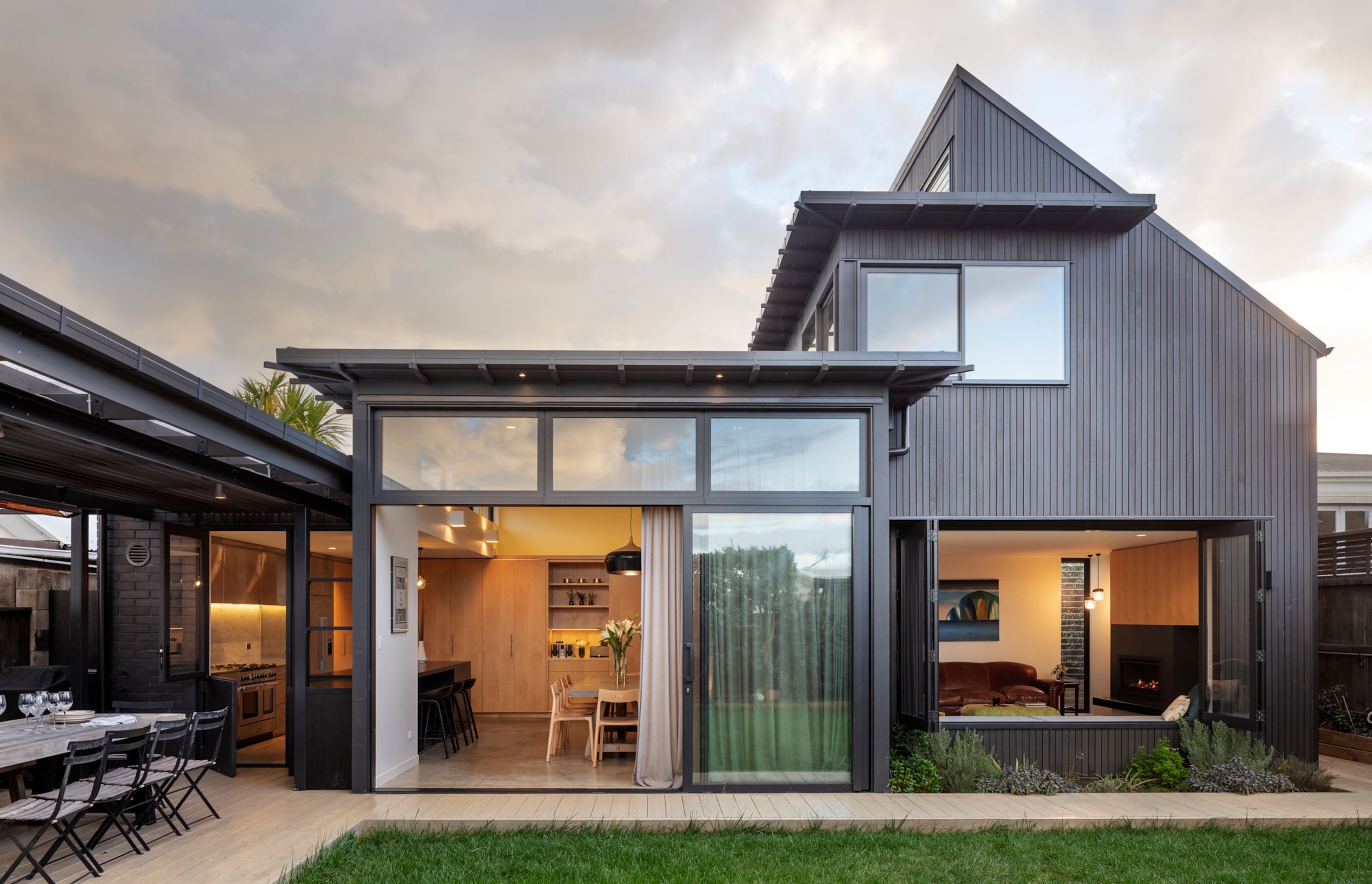 The new vertical shiplapped cedar-clad addition at the rear of the villa is stained dark to provide a clear distinction between old and new.