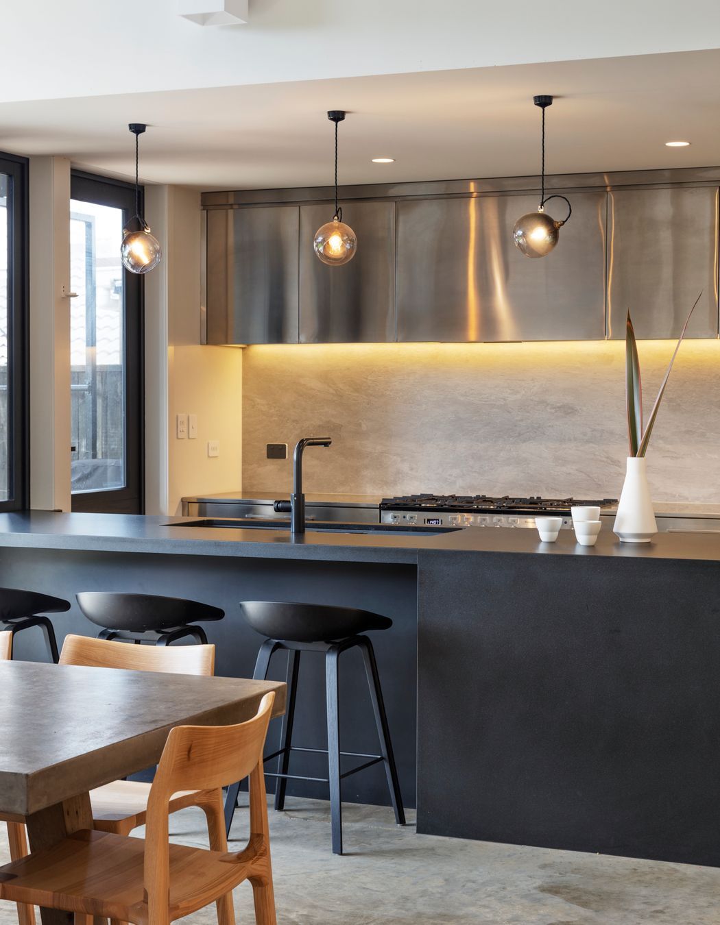 The sleek monochromatic kitchen in black, white and stainless steel.