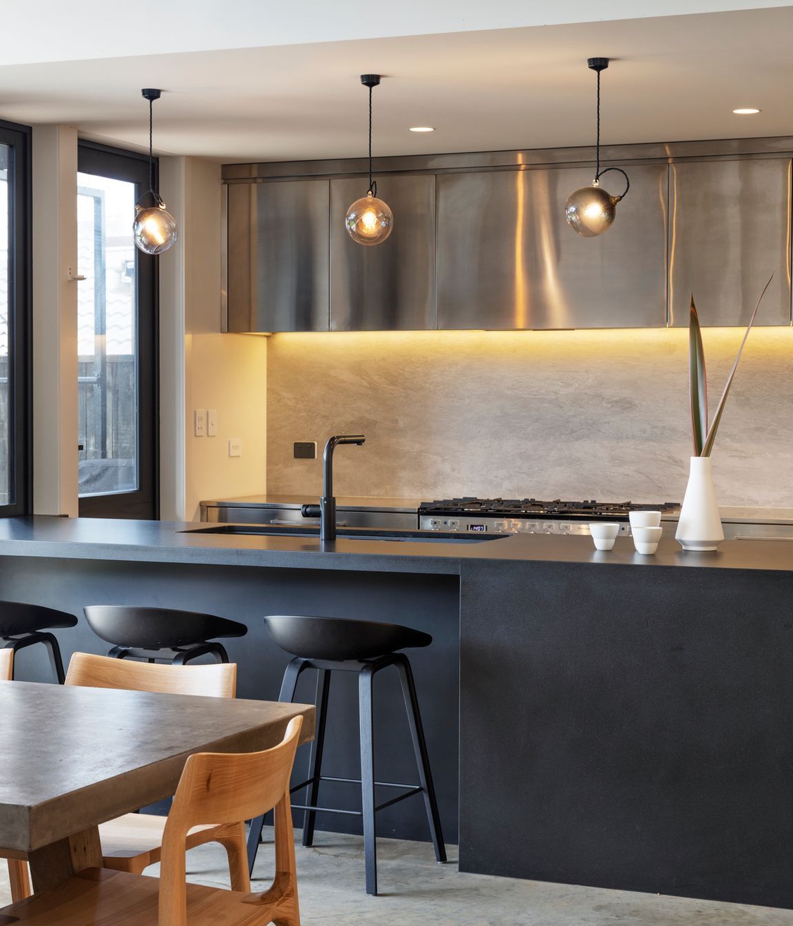 The sleek monochromatic kitchen in black, white and stainless steel.