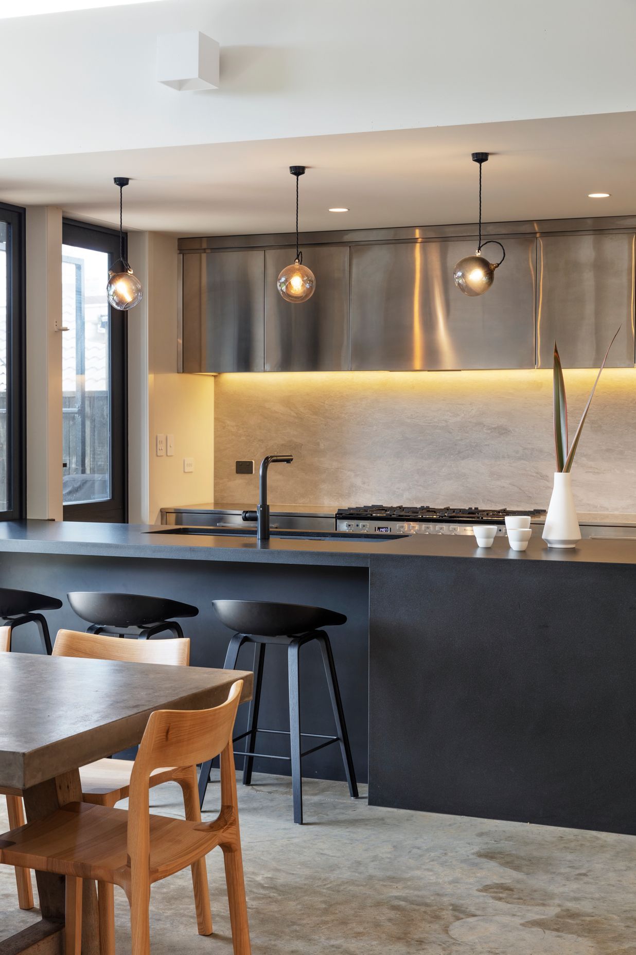 The sleek monochromatic kitchen in black, white and stainless steel.