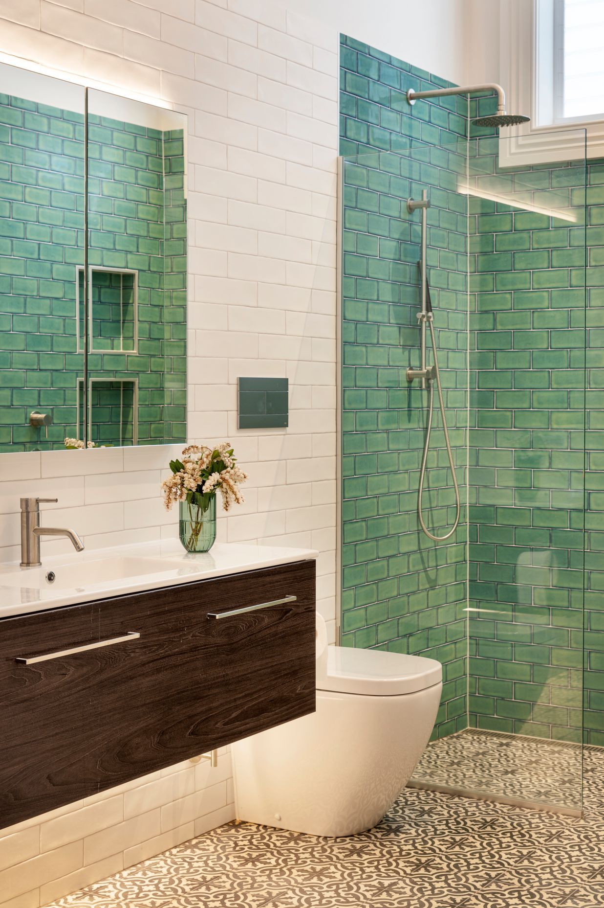 The ensuite bathroom features distinctive Victorian-style tiling on the walls and floor.