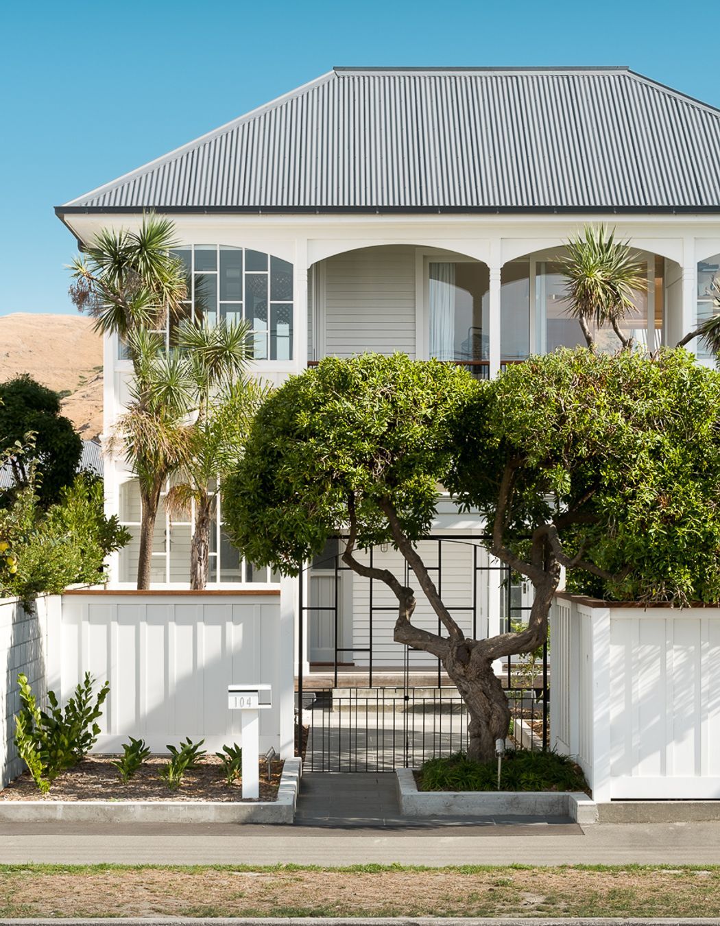 The front entry has been aligned with the front gate and an established tree.