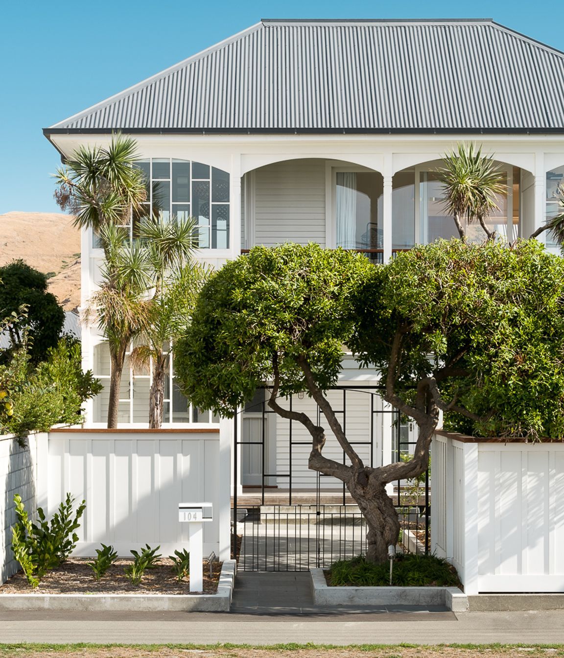 The front entry has been aligned with the front gate and an established tree.