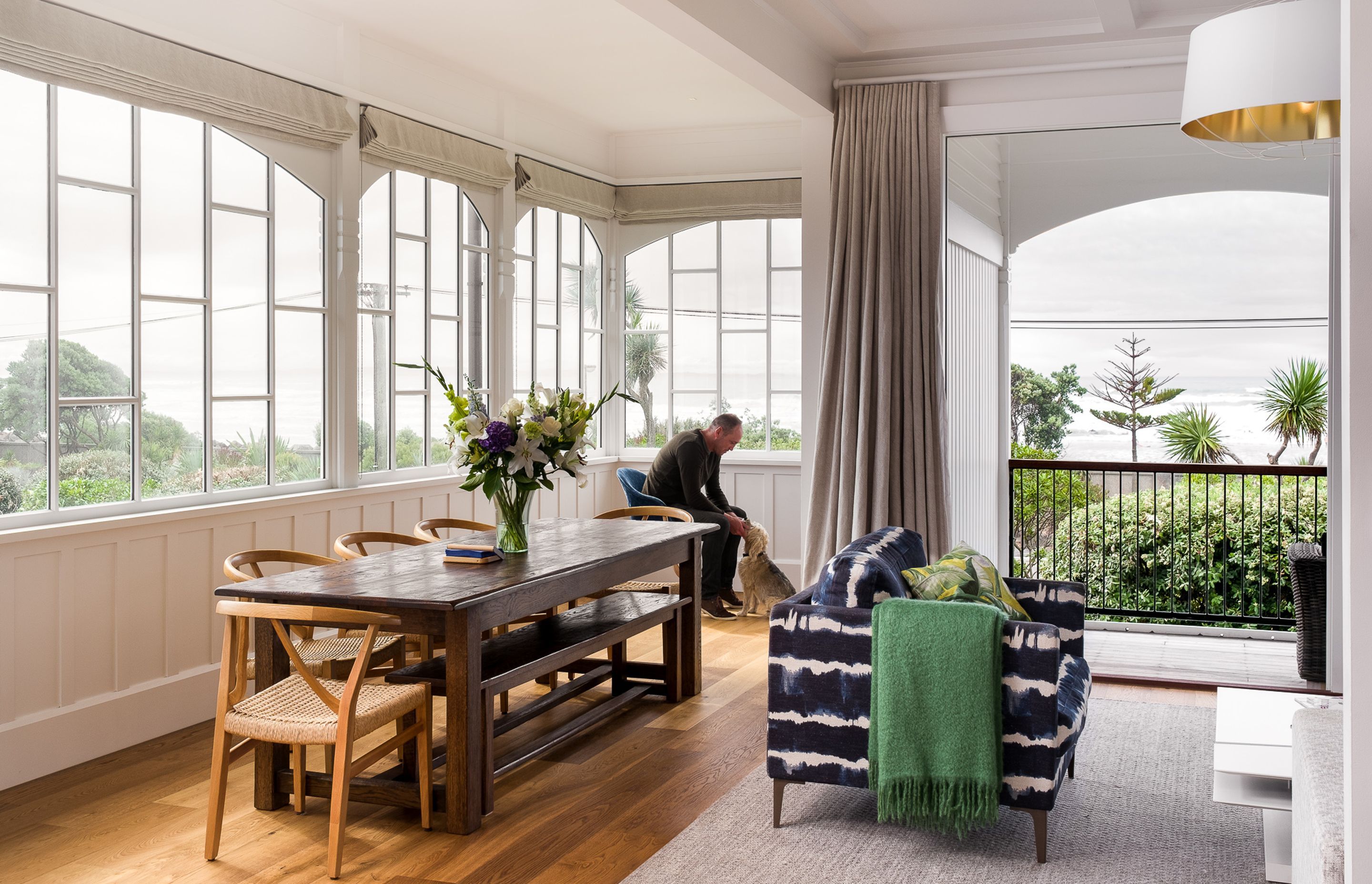The upstairs dining and living area opens onto a verandah and a magnificent view of the ocean. The distinctive single-glazed windows have been replaced with double-glazed replicas.