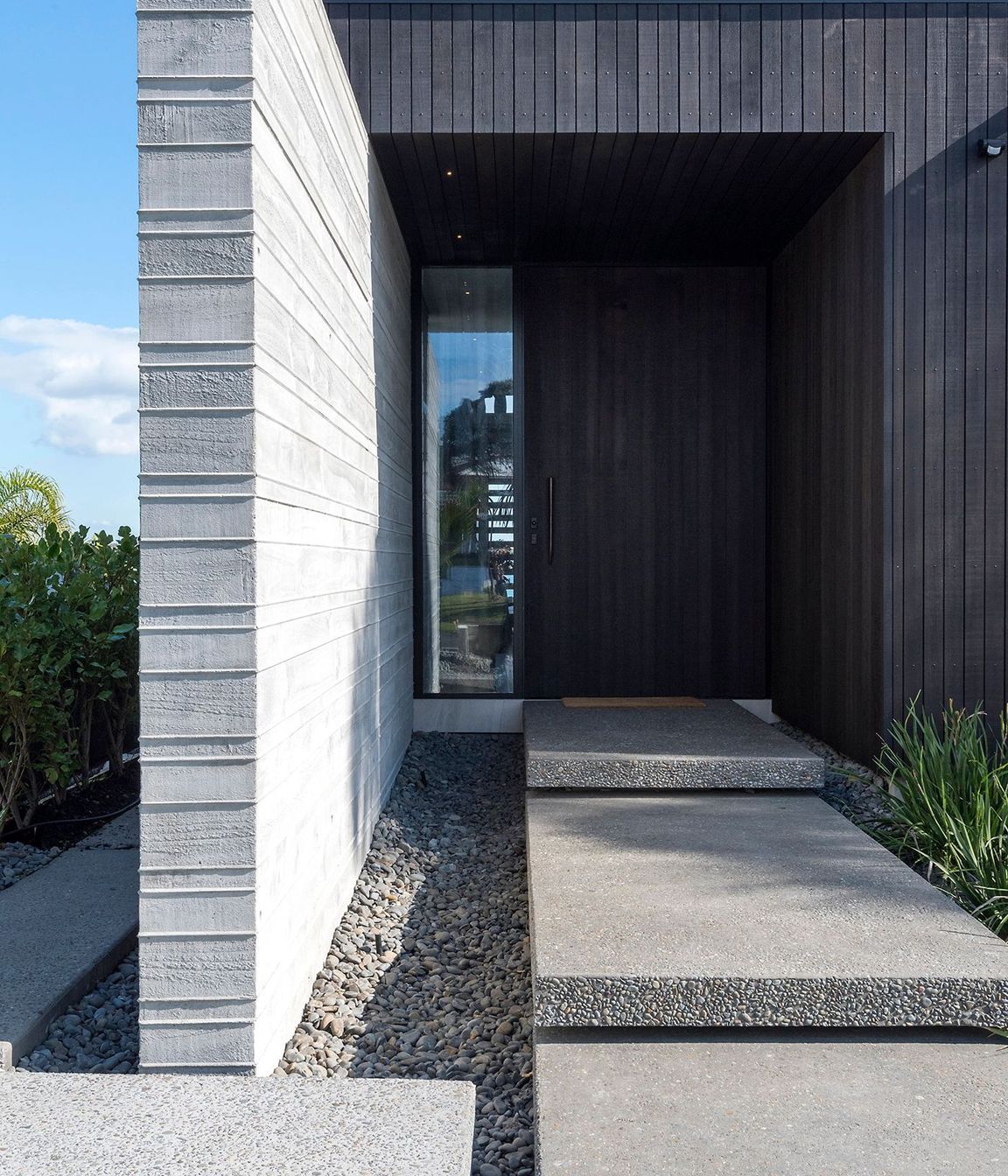The main entrance leads straight through into a double-height corridor and staircase.