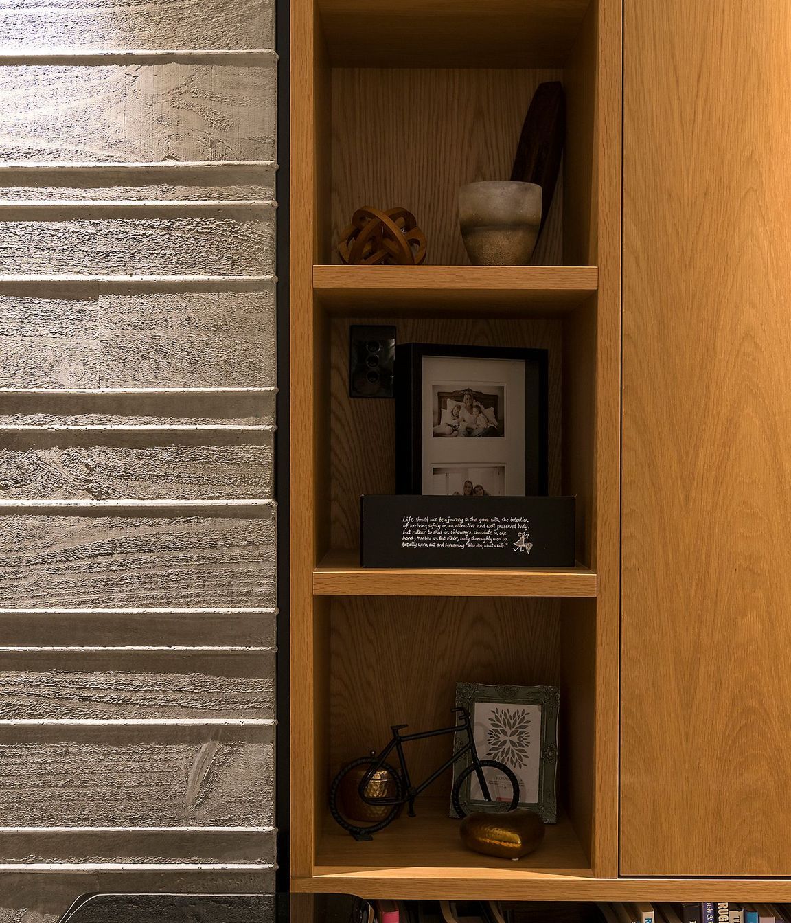 The home utilises bespoke cabinetry in pale oak, adding warmth to the concrete walls.