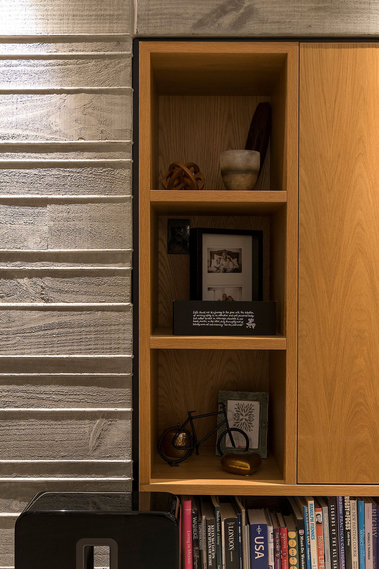 The home utilises bespoke cabinetry in pale oak, adding warmth to the concrete walls.