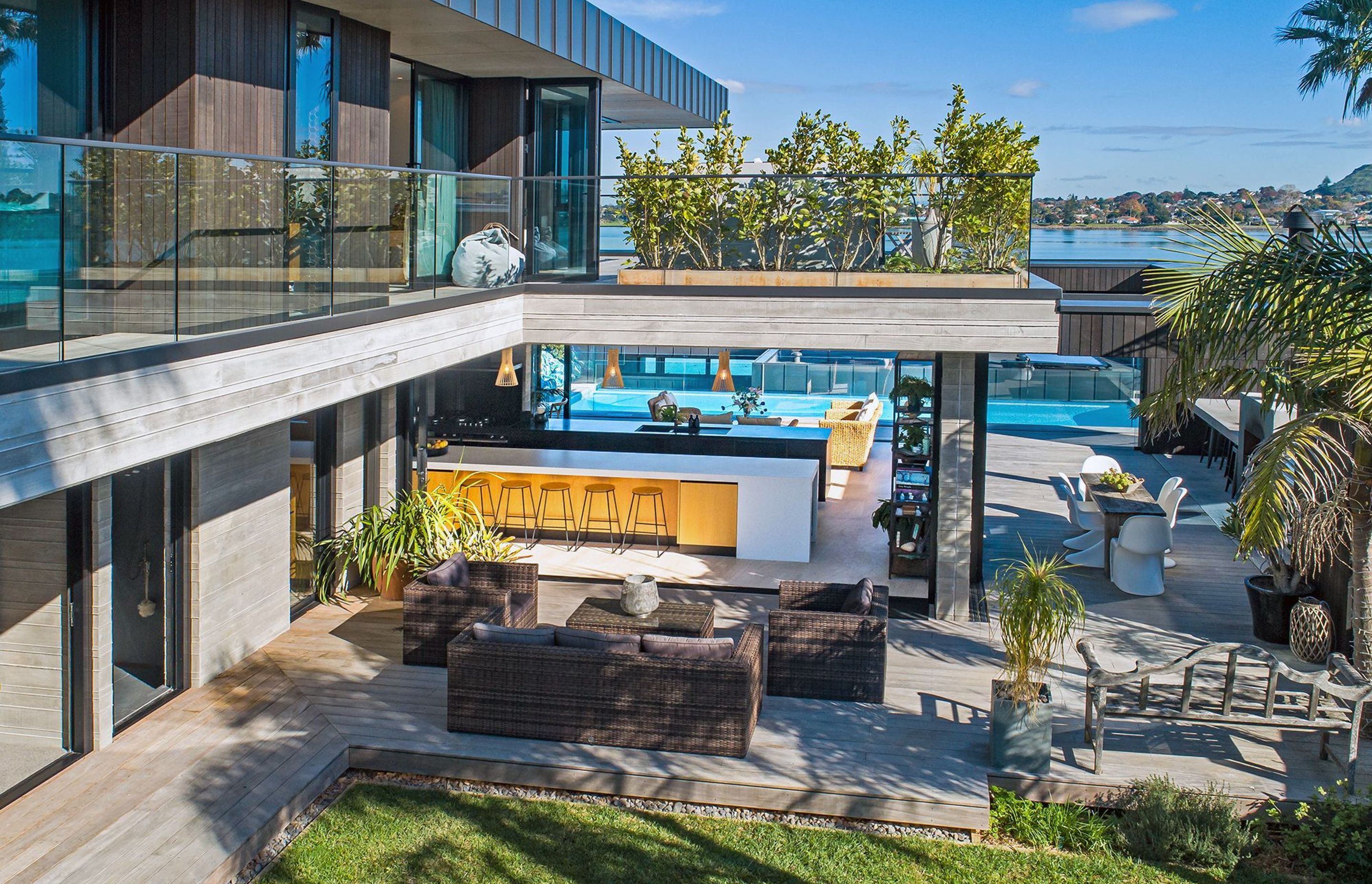 The kitchen forms the central hub to three different outdoor living areas: the lounge (front), outdoor kitchen and dining space (right) and swimming pool (rear).