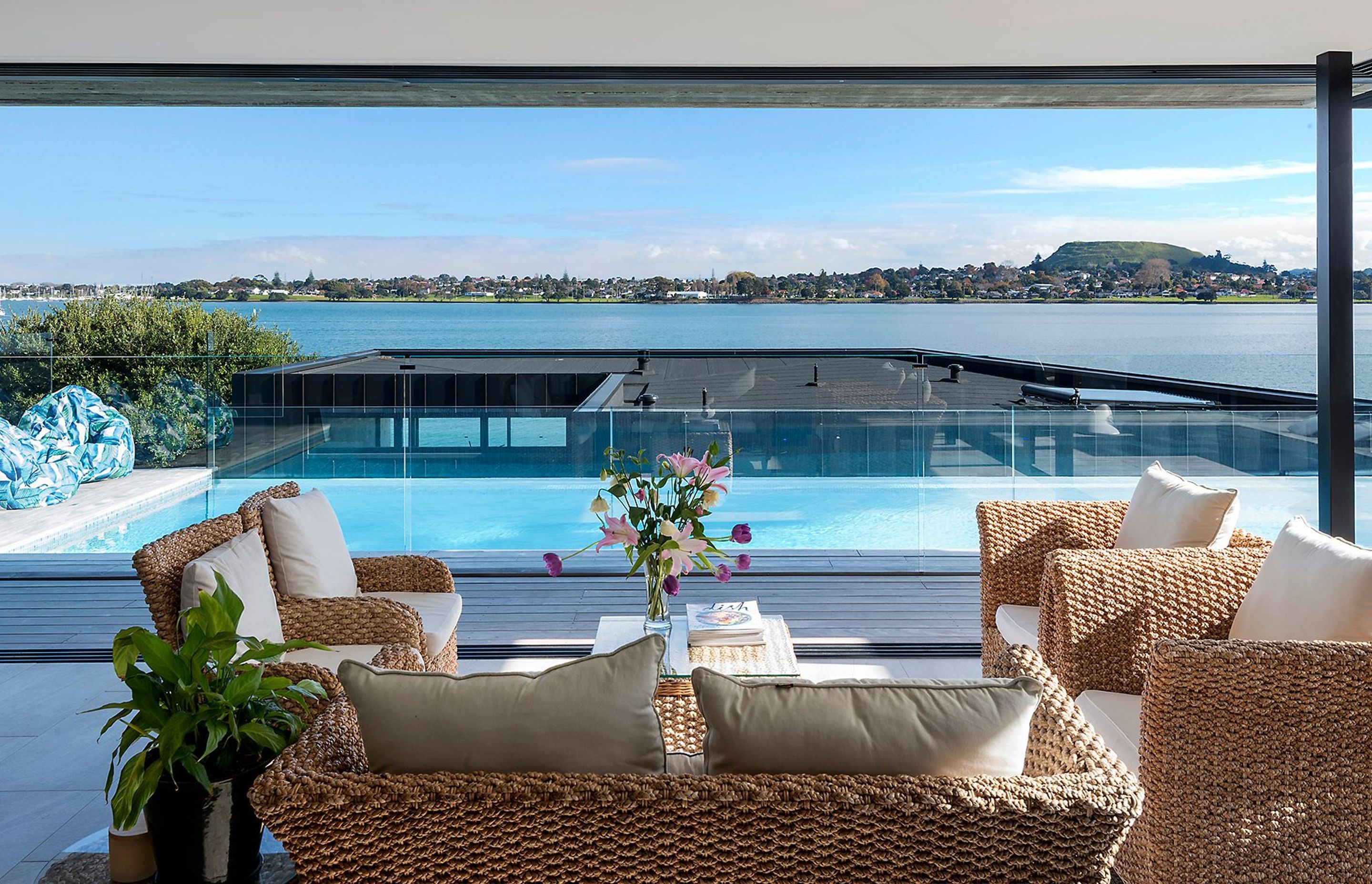 A relaxed and sunny lounging space overlooks the pool and the river view.