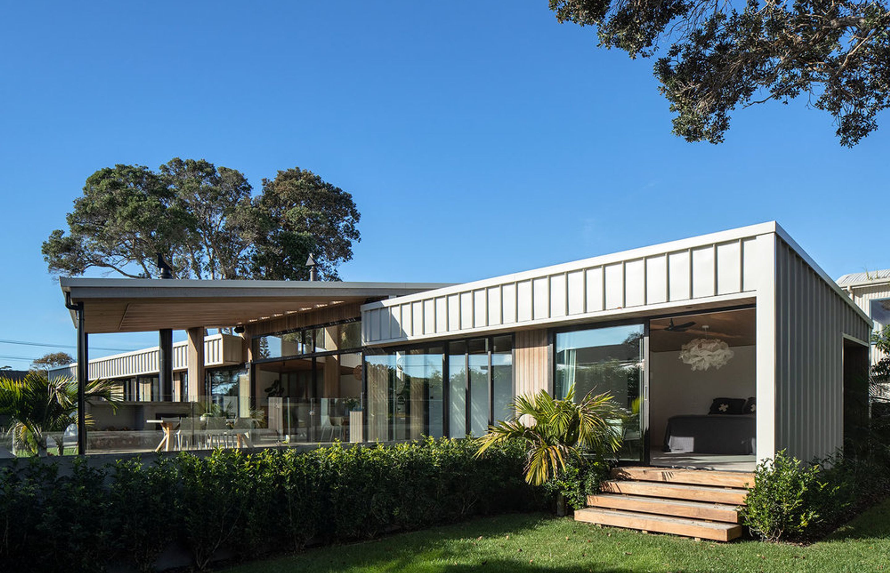 The view from the western end of the house, with the master bedroom opening up onto a grass lawn area.