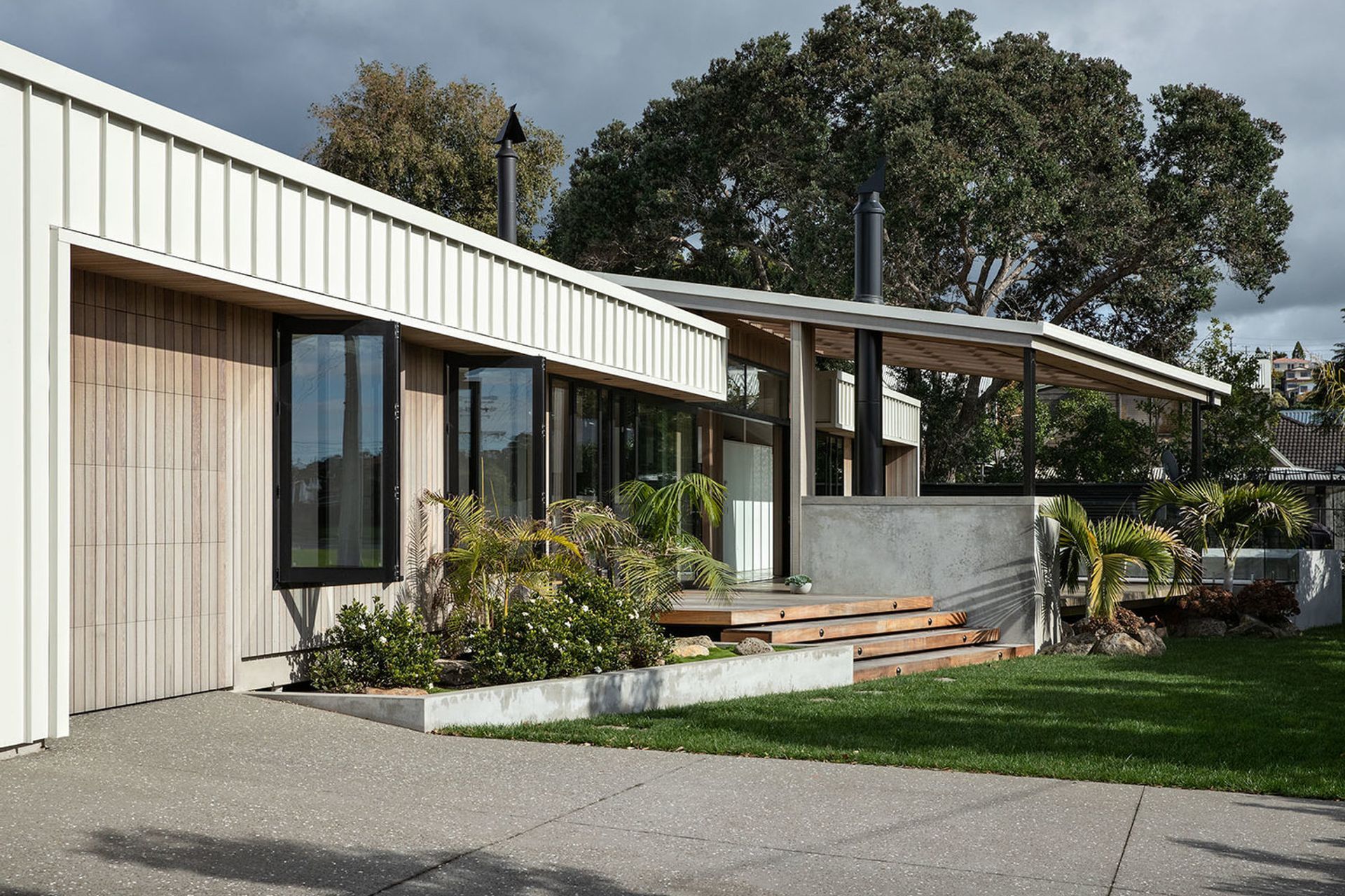 The large garage has been made discreet with vertical cedar panelling on the walls and doors.